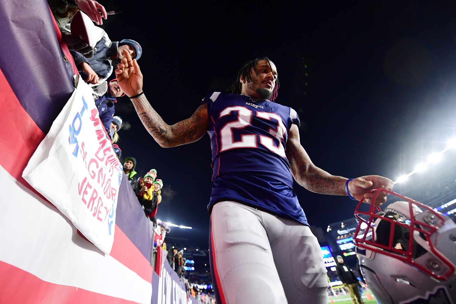 Patrick Chung signs autographs for New England Patriots fans after a win against the Buffalo Bills on Dec. 21, 2019.
