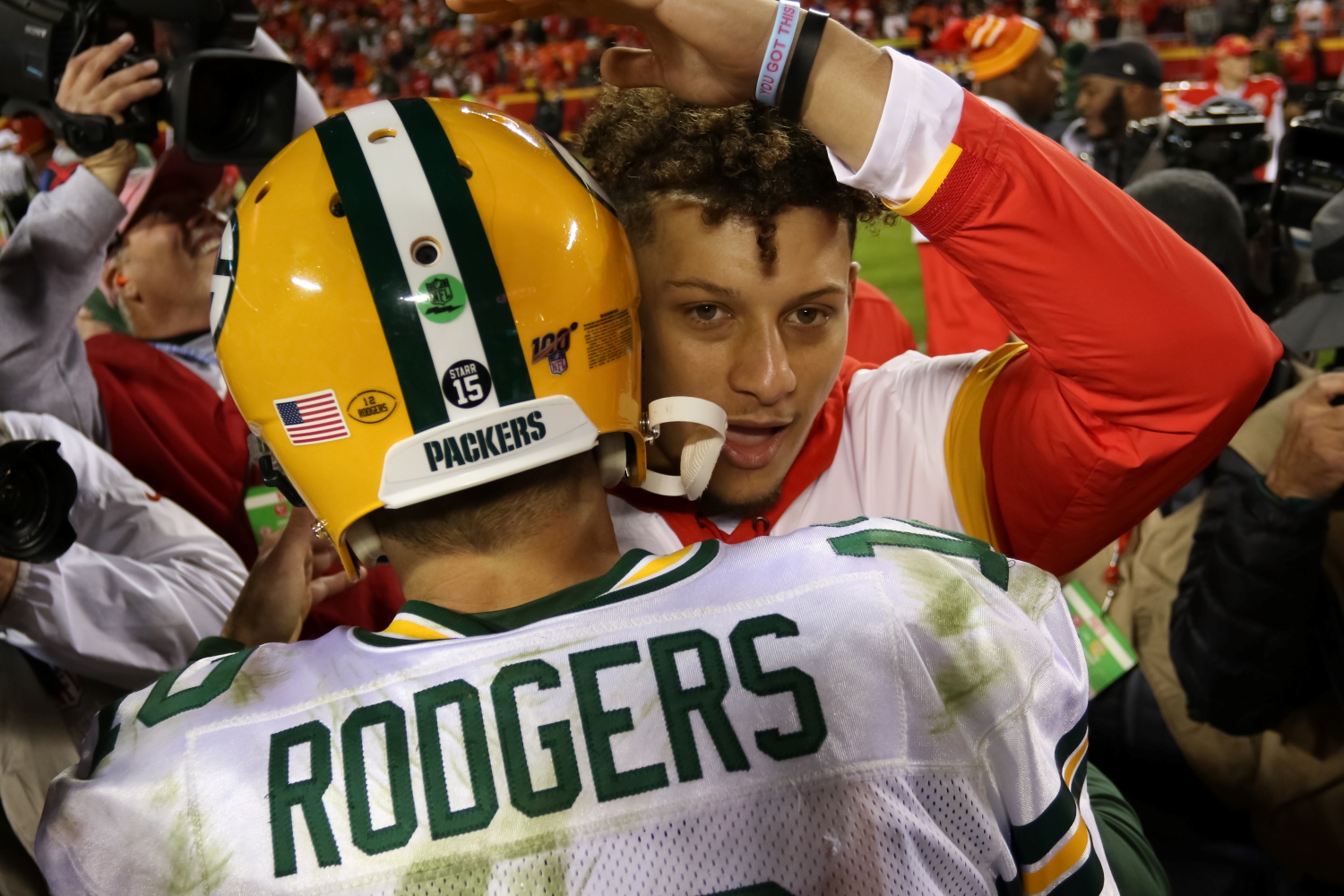 Kansas City Chiefs quarterback Patrick Mahomes embraces Green Bay Packers star Aaron Rodgers after a game from the 2019 season.