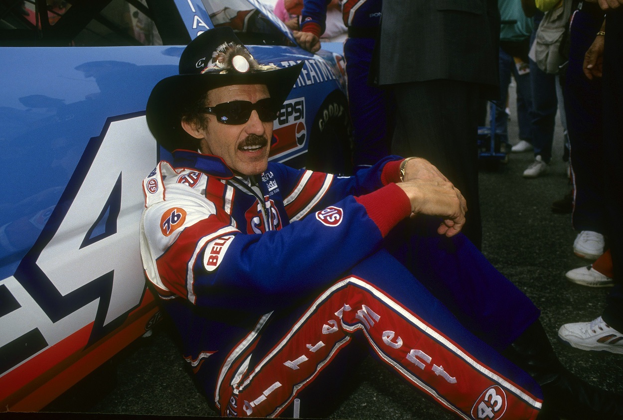 Richard Petty sits by his famous No. 43 car ahead of the 1992 NASCAR Cup Series Daytona 500