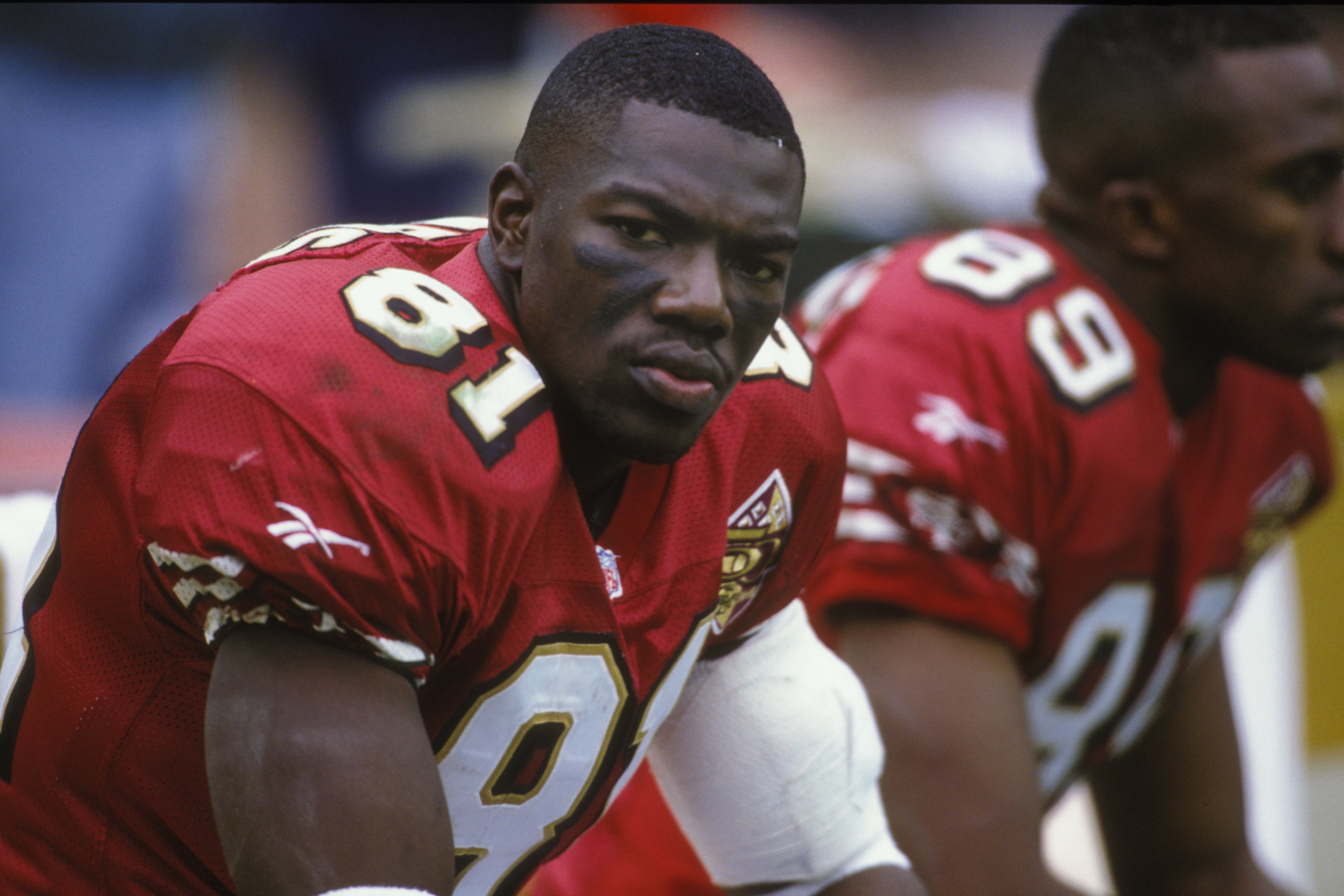 Terrell Owens looks on from the bench in 1996