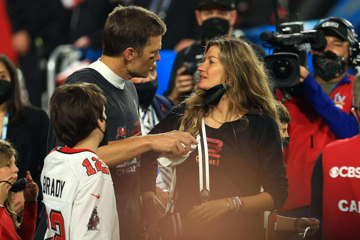 Tom Brady and Gisele Bundchen talk on the field after Super Bowl 55