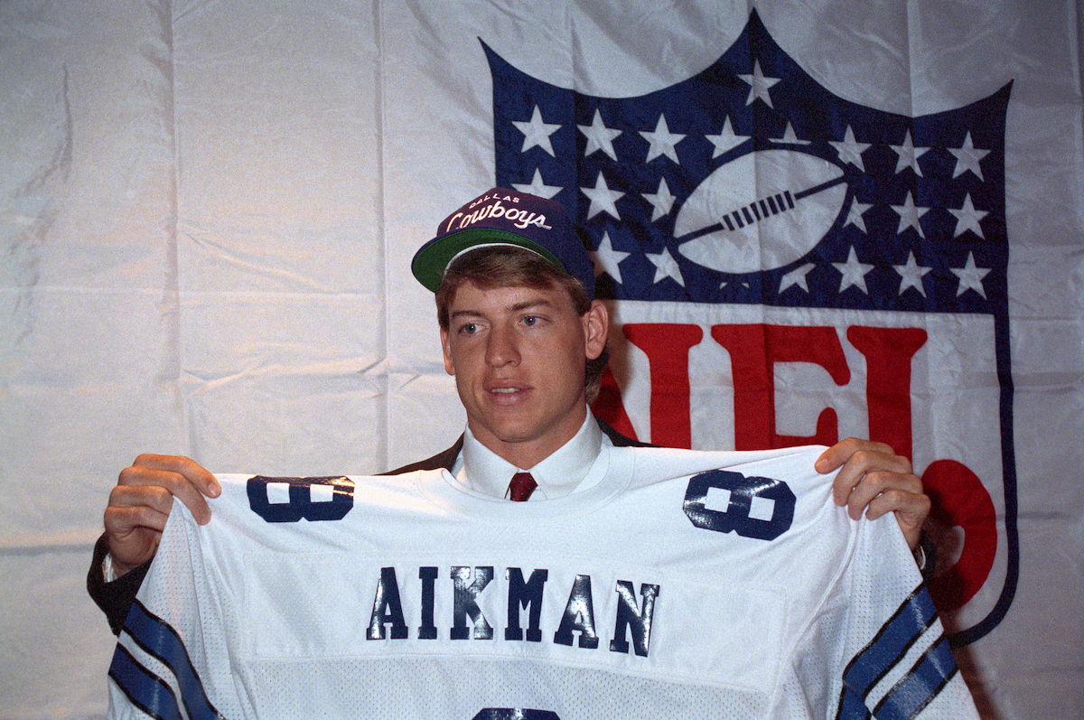 Troy Aikman holds up his jersey after being named the No. 1 draft pick by the Dallas Cowboys