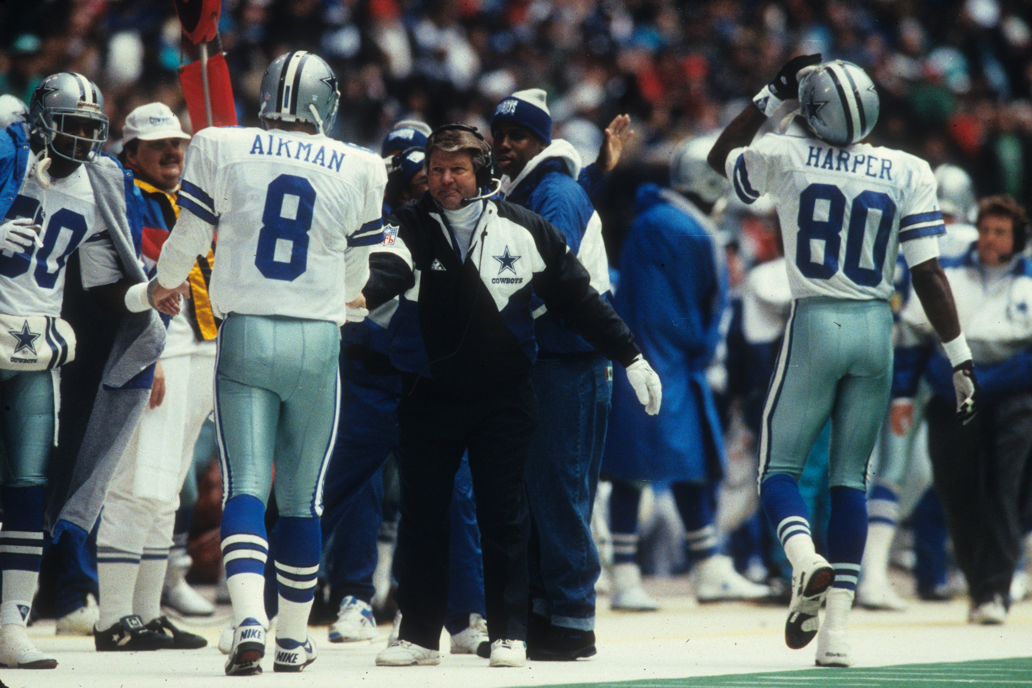 Troy Aikman and Jimmy Johnson talking on the sideline during a Cowboys game