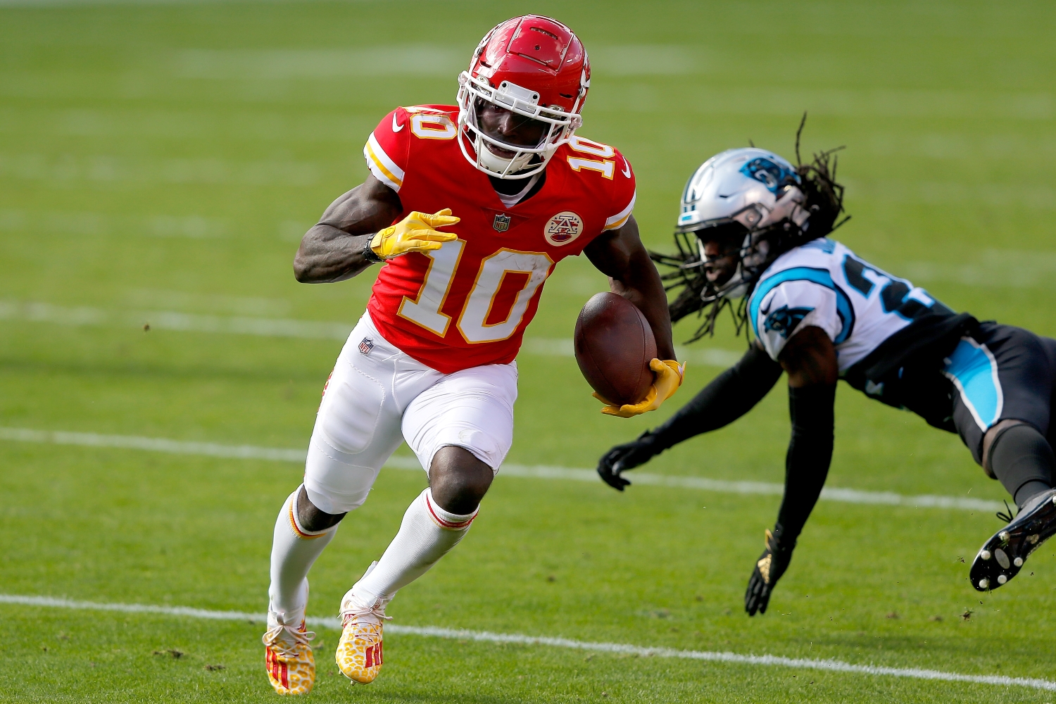 Tyreek Hill of the Kansas City Chiefs carries the ball after making a catch against the Carolina Panthers in the second quarter at Arrowhead Stadium.