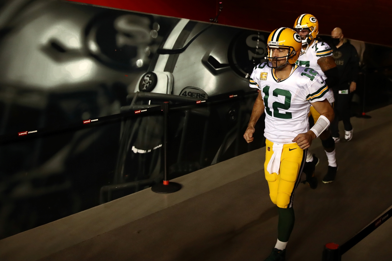 Green Bay Packers quarterback Aaron Rodgers exits the tunnel with a teammate