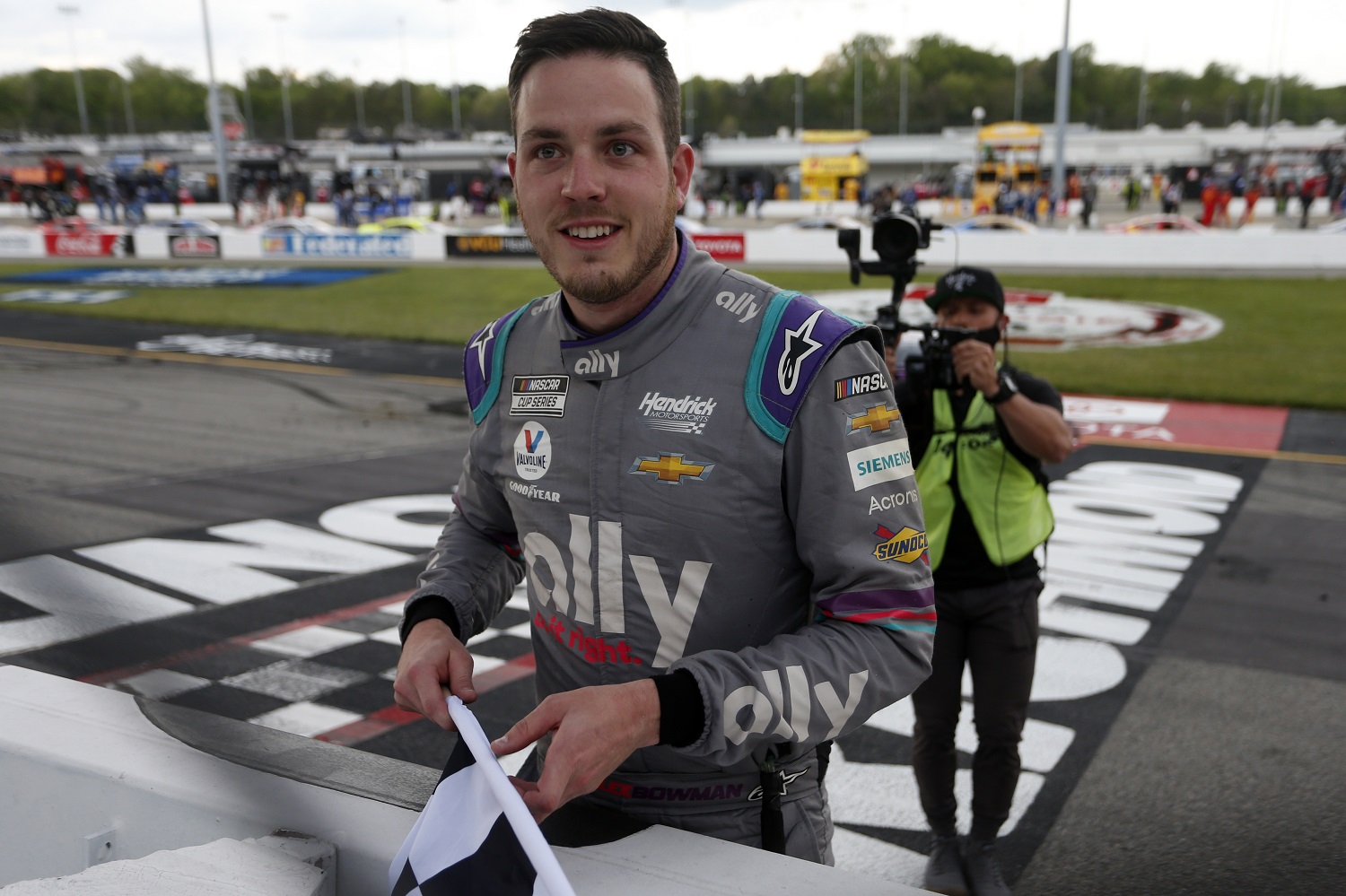 Alex Bowman celebrates with the checkered flag after winning the NASCAR Cup Series Toyota Owners 400 at Richmond Raceway. | Photo by Brian Lawdermilk/Getty Images