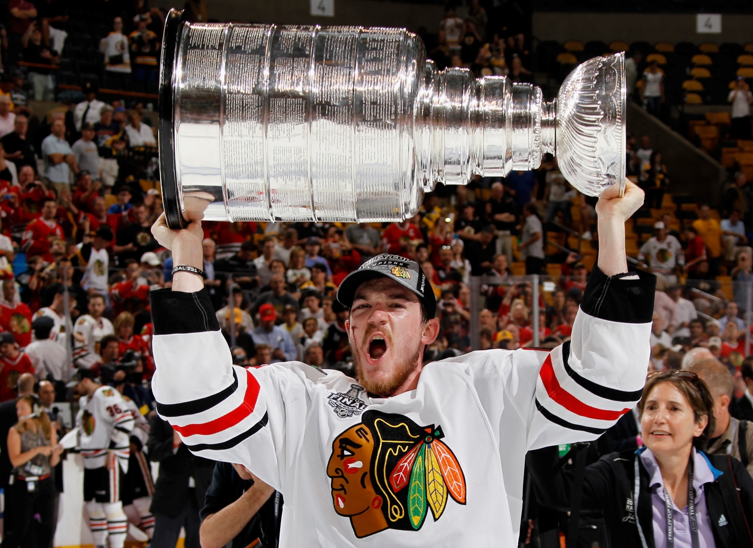 Chicago Blackhawks forward Andrew Shaw hoists the Stanley Cup after his team defeated the Boston Bruins.