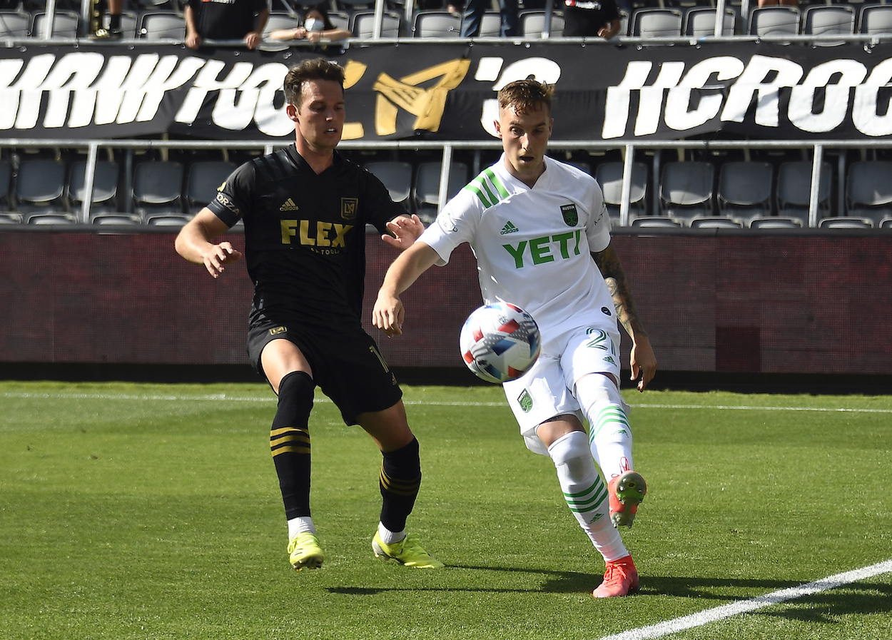 Austin FC player battles LAFC player for ball