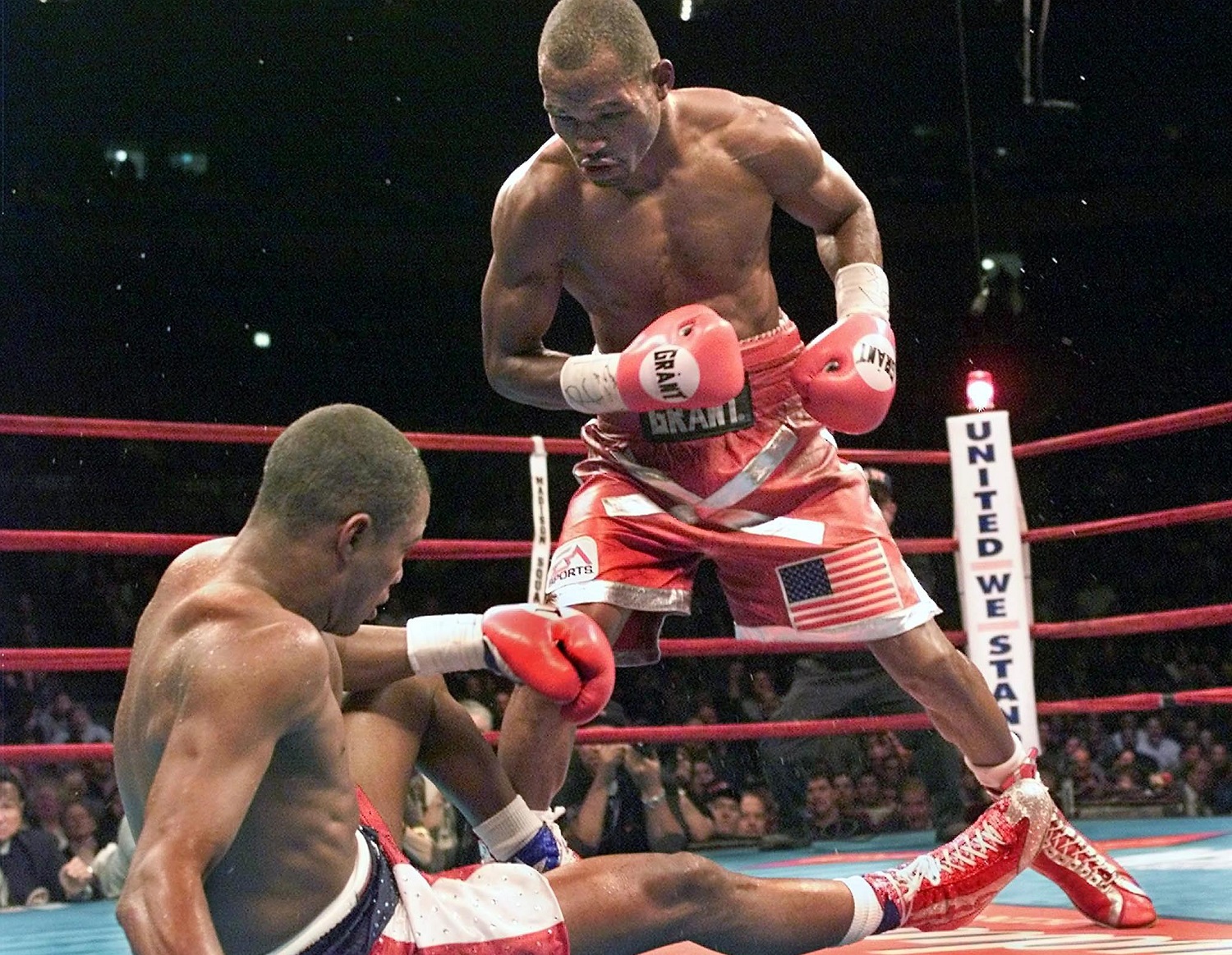 Bernard Hopkins, right, knocks down Felix Trinidad during their title unification match at Madison Square Garden on Sept. 29, 2001. Hopkins won by TKO in the 12th round to secure the undisputed middleweight championship. | Timothy A. Clary/AFP via Getty Images