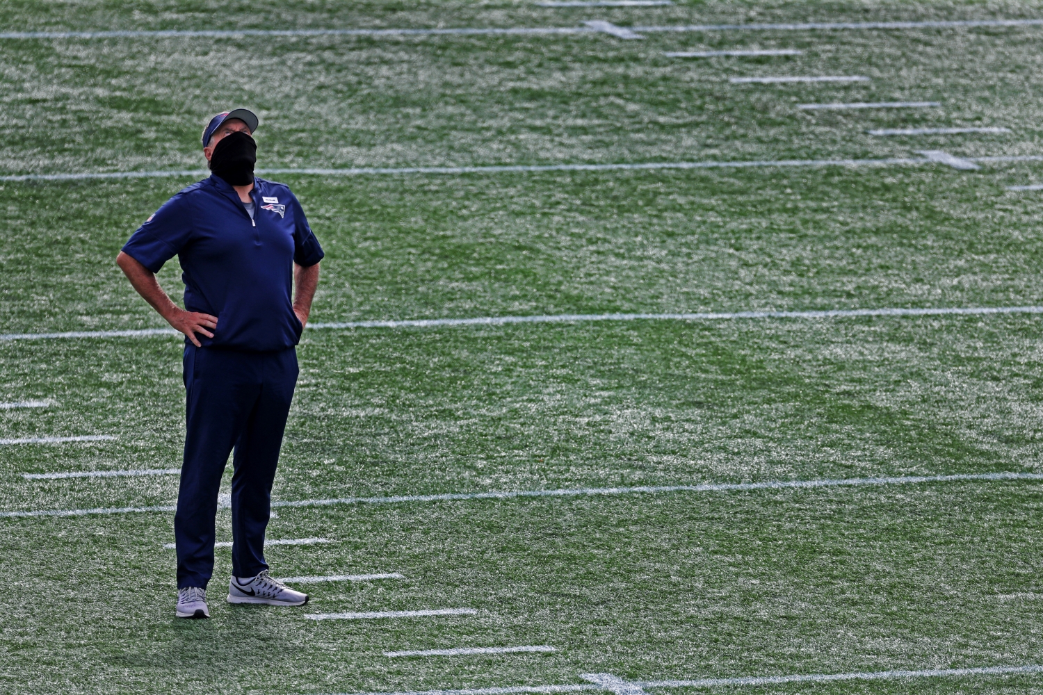 New England Patriots coach Bill Belichick checks the sky for weather conditions.