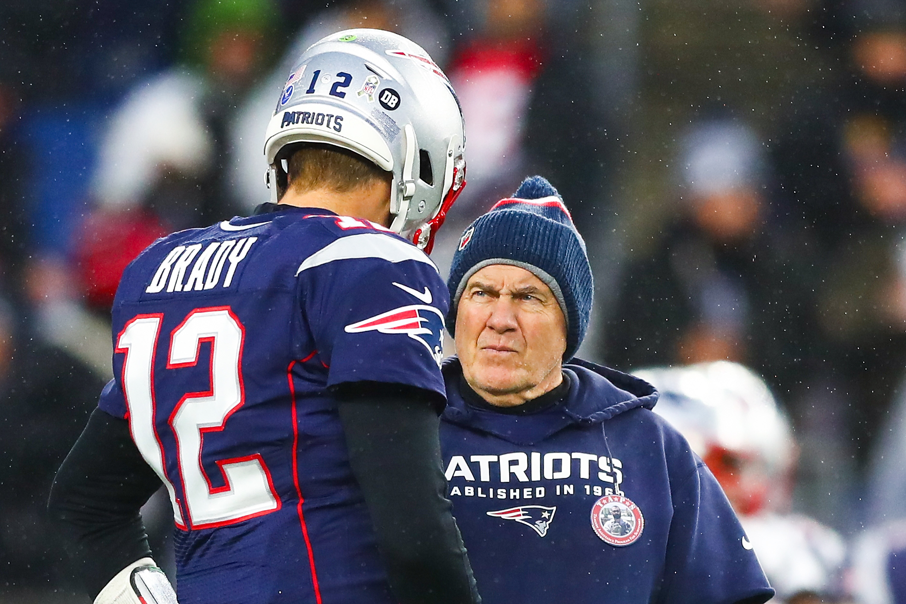 Quarterback Tom Brady talks to head coach Bill Belichick of the New England Patriots before a game against the Dallas Cowboys at Gillette Stadium on November 24, 2019 in Foxborough, Massachusetts.