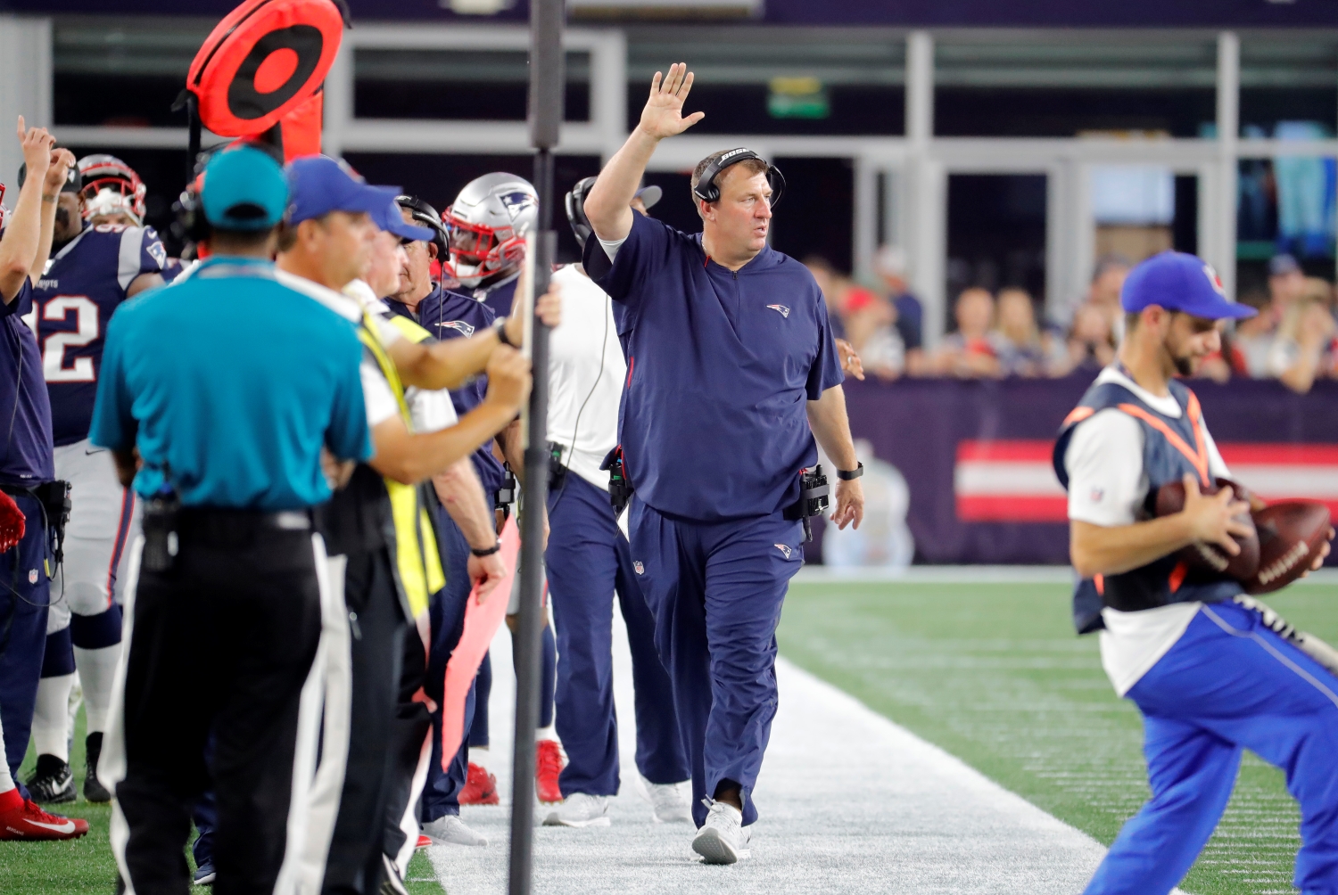 New England Patriots defensive line coach Bret Bielema walks on the sideline during a preseason game.
