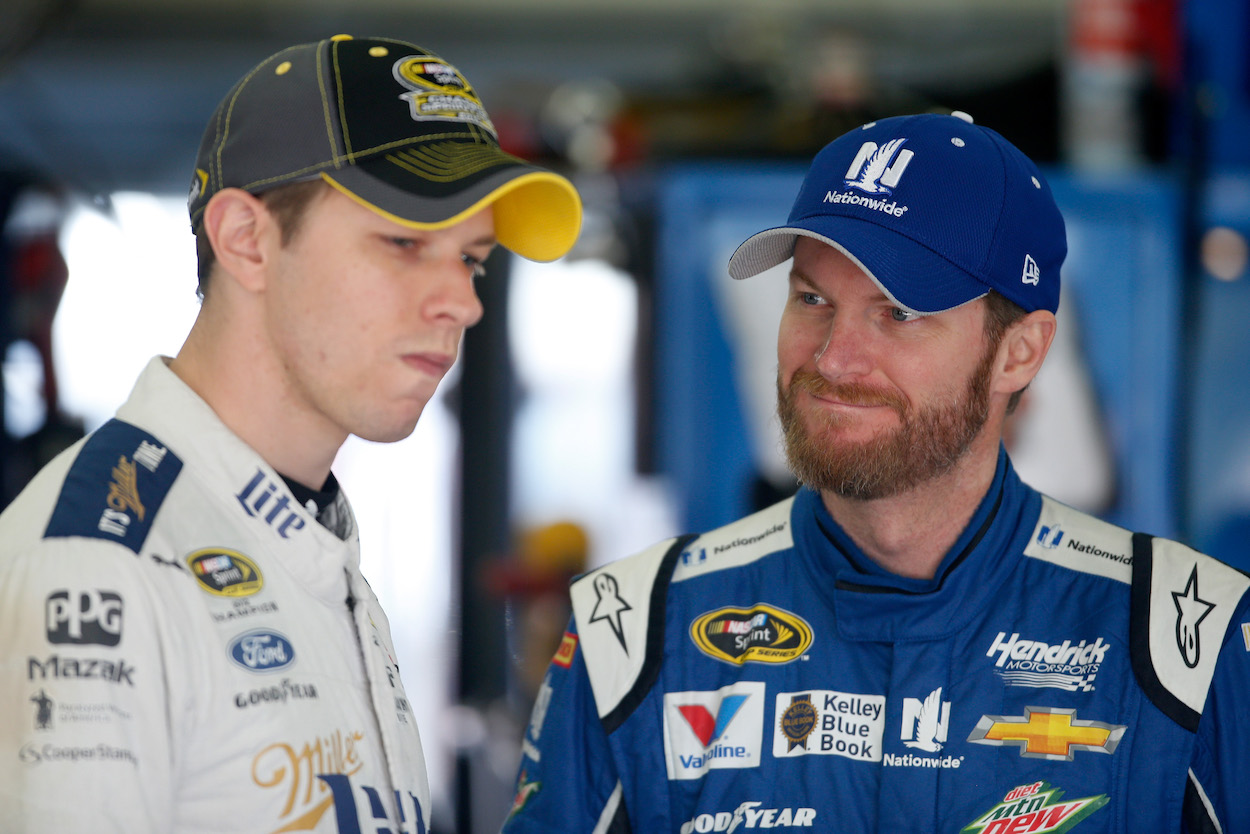 Dale Earnhardt Jr. and Brad Keselowski talking in garage