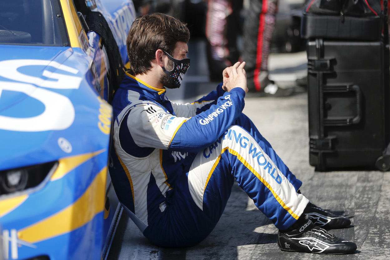 Daniel Suarez sits beside vehicle before race