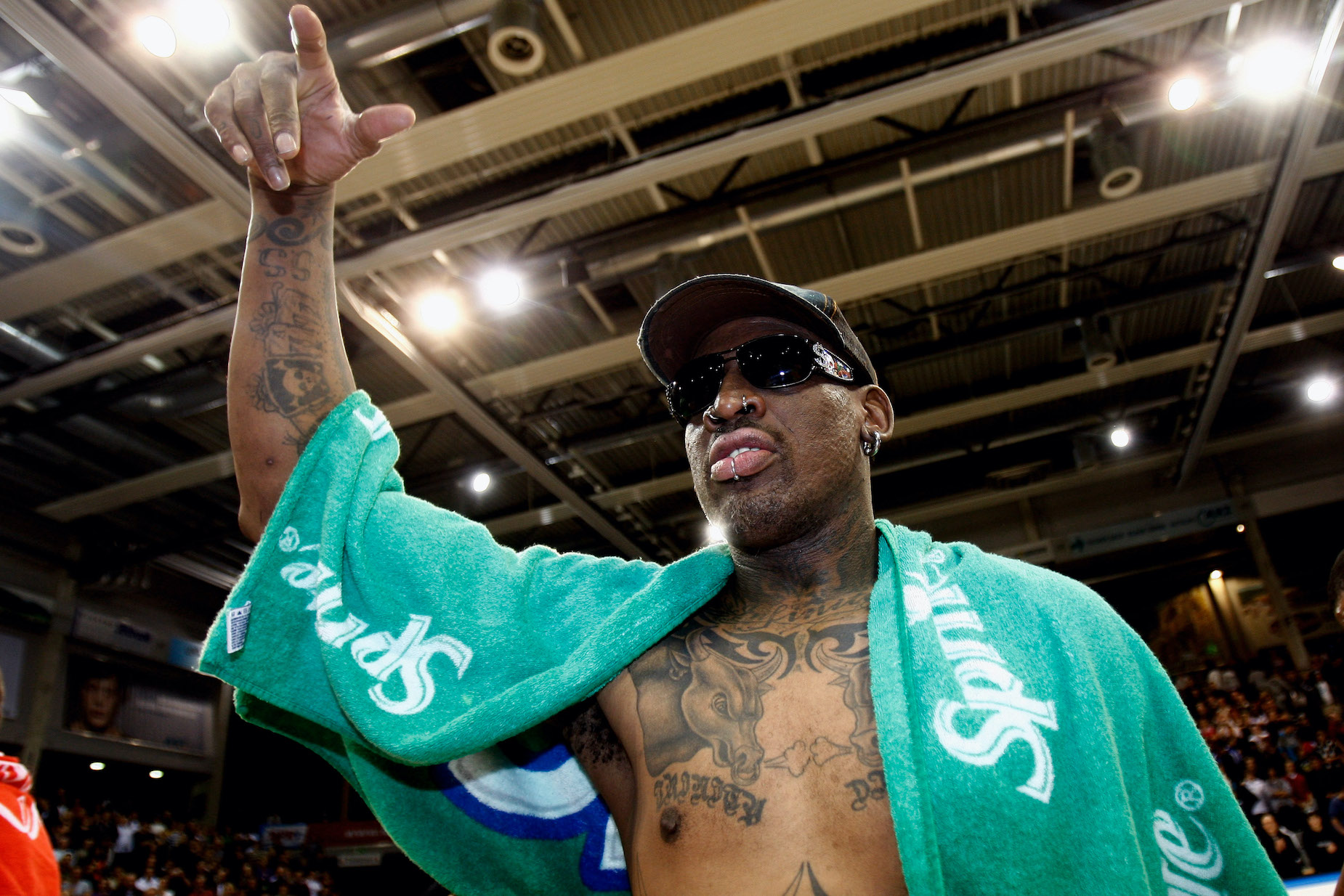 NBA legend Dennis Rodman gestures to the crowd during a 2009 exhibition in Germany.