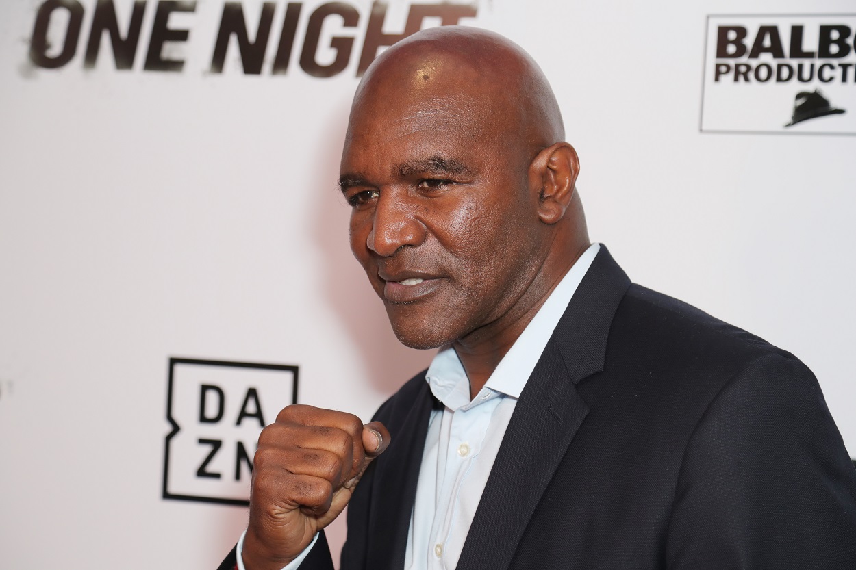 Legendary boxer Evander Holyfield poses for a photo at a boxing event.