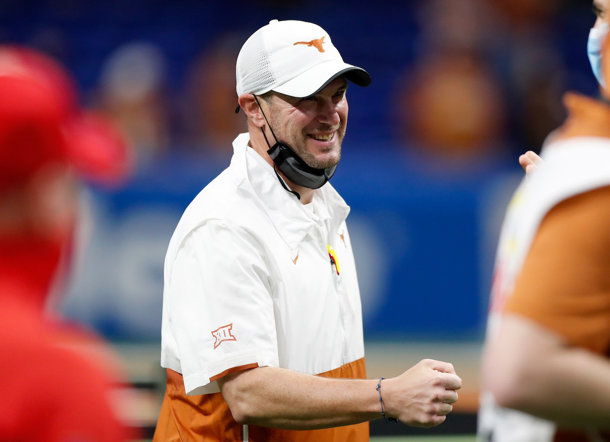 Former Texas Longhorns coach Tom Herman laughs