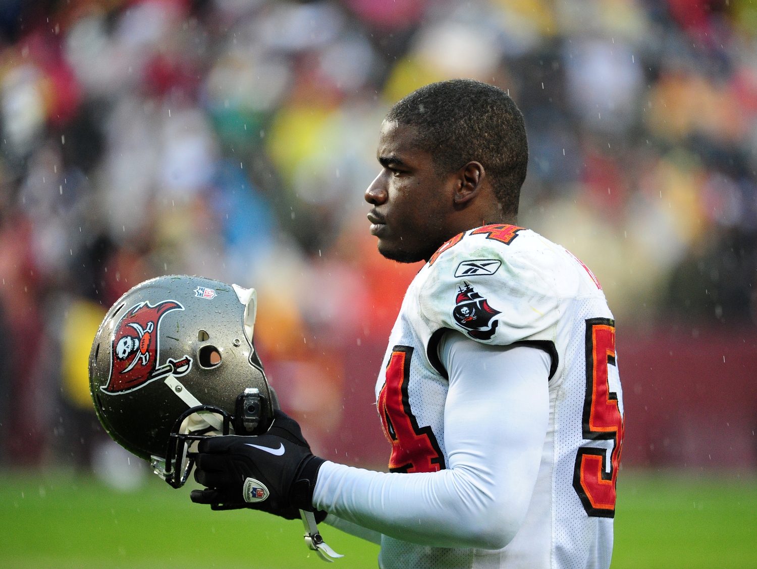 Tampa Bay Buccaneers linebacker Geno Hayes holds his helmet during a game.