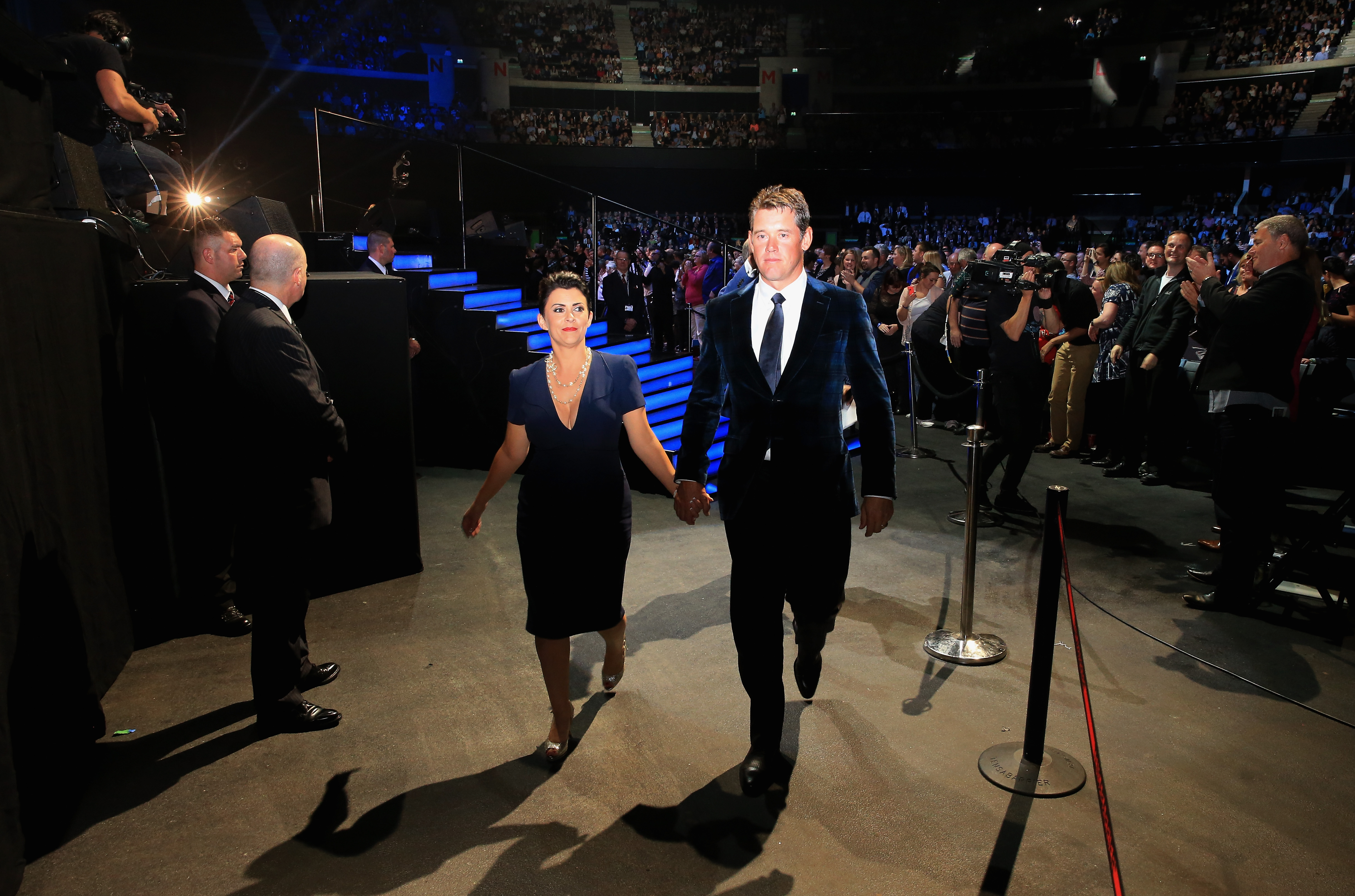 Lee Westwood and wife Laurae Westwood leave the stage during the 2014 Ryder Cup Gala Concert