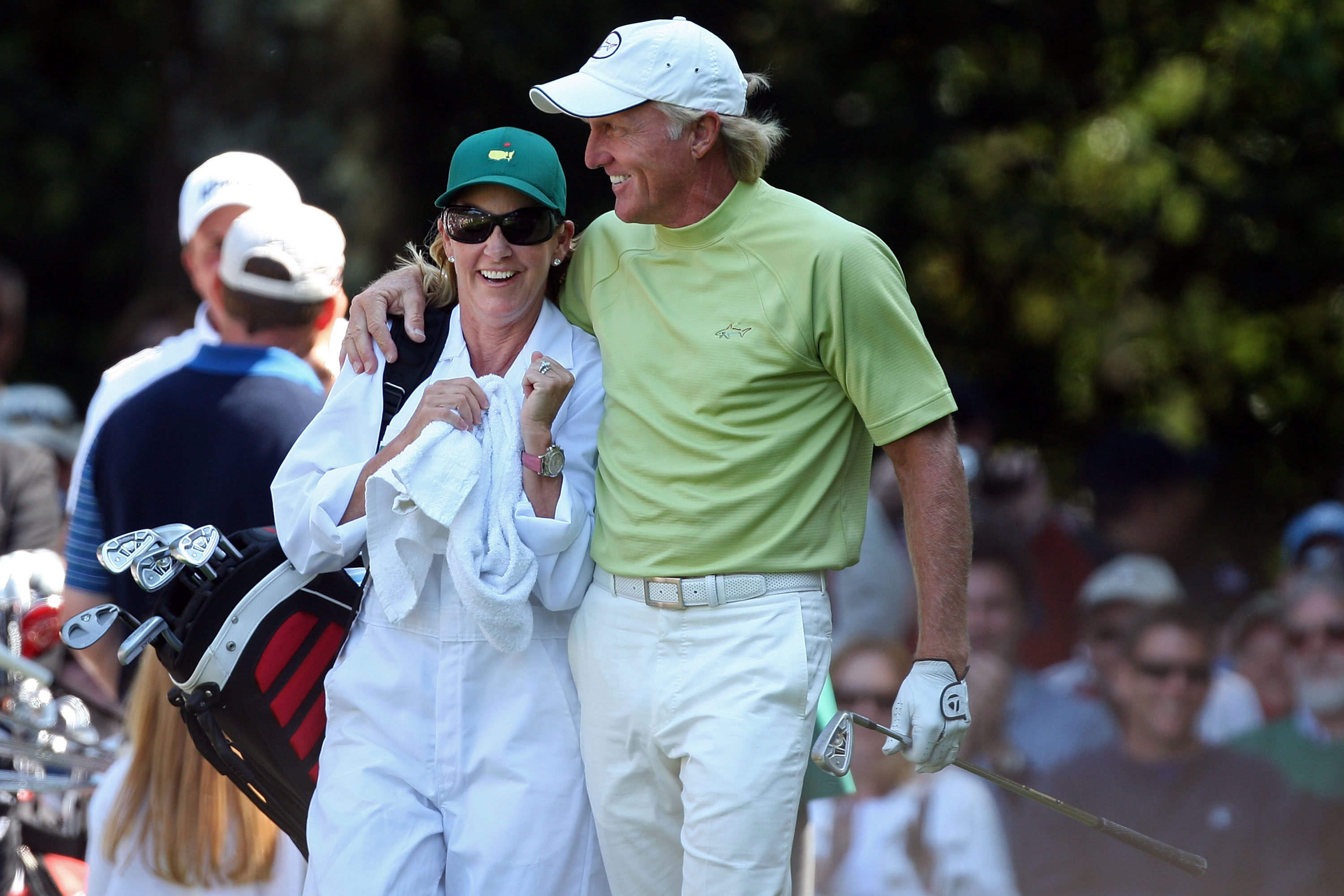Golfer Greg Norman celebrates a hole-in-one with his wife/caddie Chris Evert at the 2009 Augusta