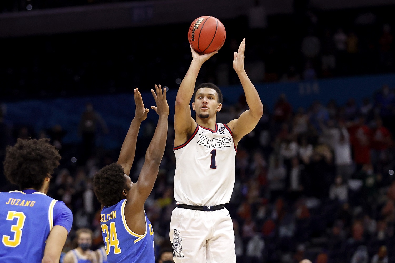 Jalen Suggs of the Gonzaga Bulldogs shoots the game-winning 3-pointer in overtime to defeat the UCLA Bruins, 93-90, during the 2021 NCAA Tournament semifinal at Lucas Oil Stadium in Indianapolis. | Photo by Jamie Squire/Getty Images