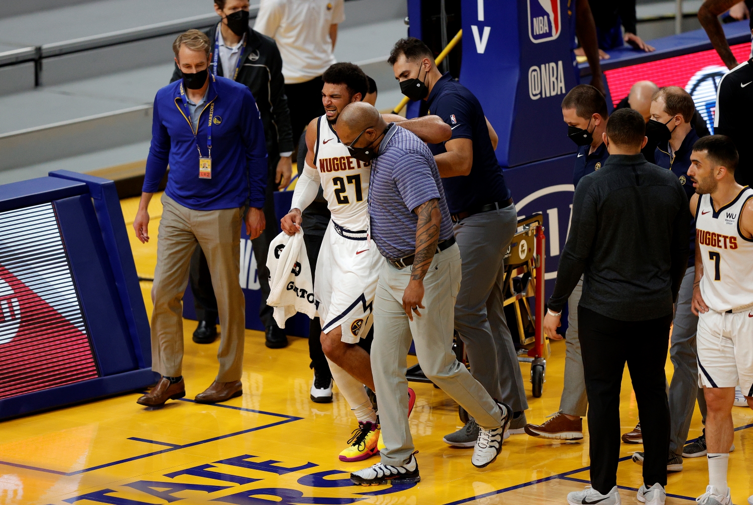 Denver Nuggets star Jamal Murray gets helped off the court after he suffered a knee injury.