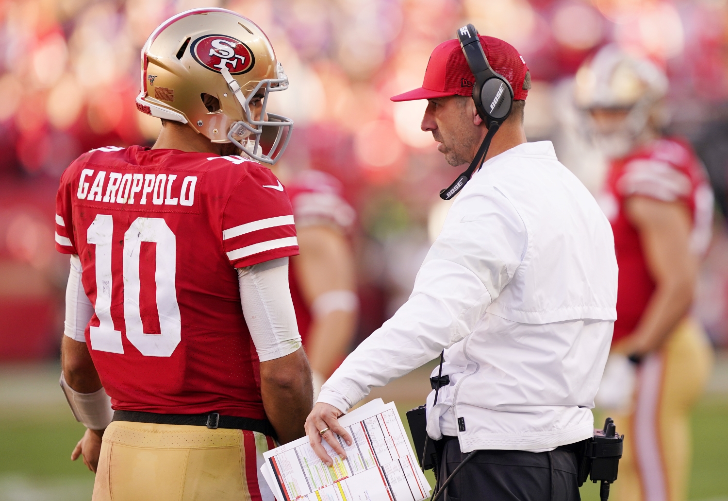 San Francisco 49ers quarterback Jimmy Garoppolo speaks to head coach Kyle Shanahan during a 2020 playoff game against the Minnesota Vikings.