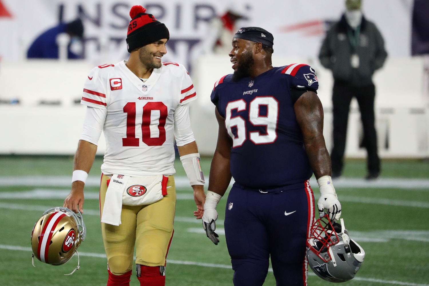 San Francisco 49ers quarterback Jimmy Garoppolo greets former New England Patriots teammate Shaq Mason during a game from the 2020 NFL season.