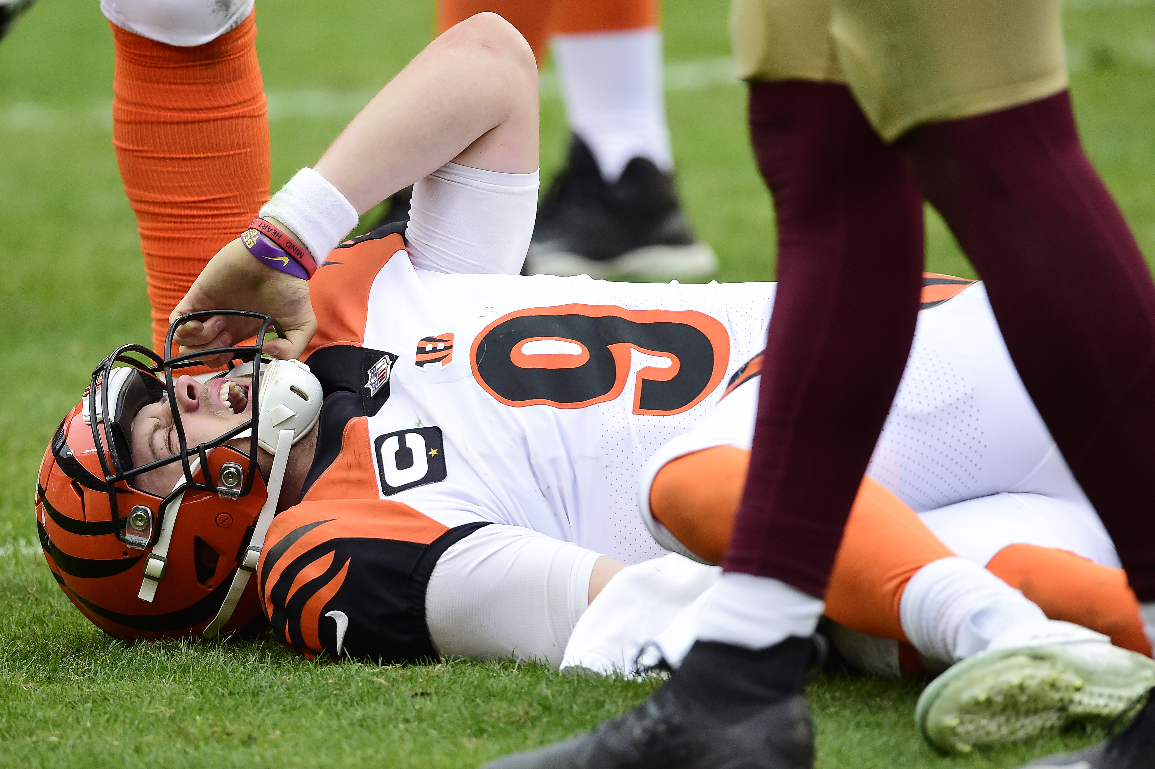 Joe Burrow of the Cincinnati Bengals reacts after injuring his left knee in the third quarter against the Washington Football Team at FedExField on November 22, 2020, in Landover, Maryland.