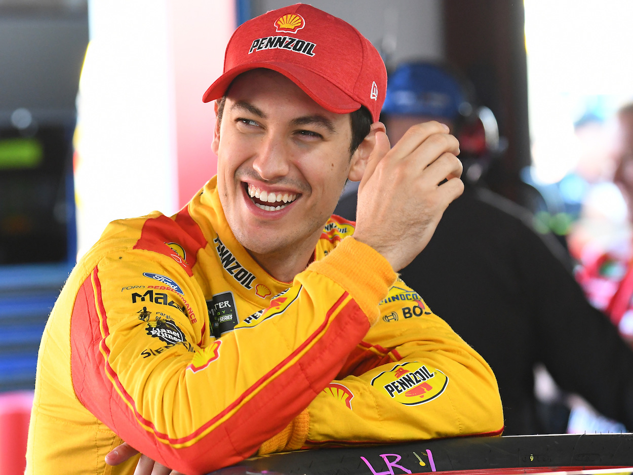 Joey Logano smiles and laughs before race