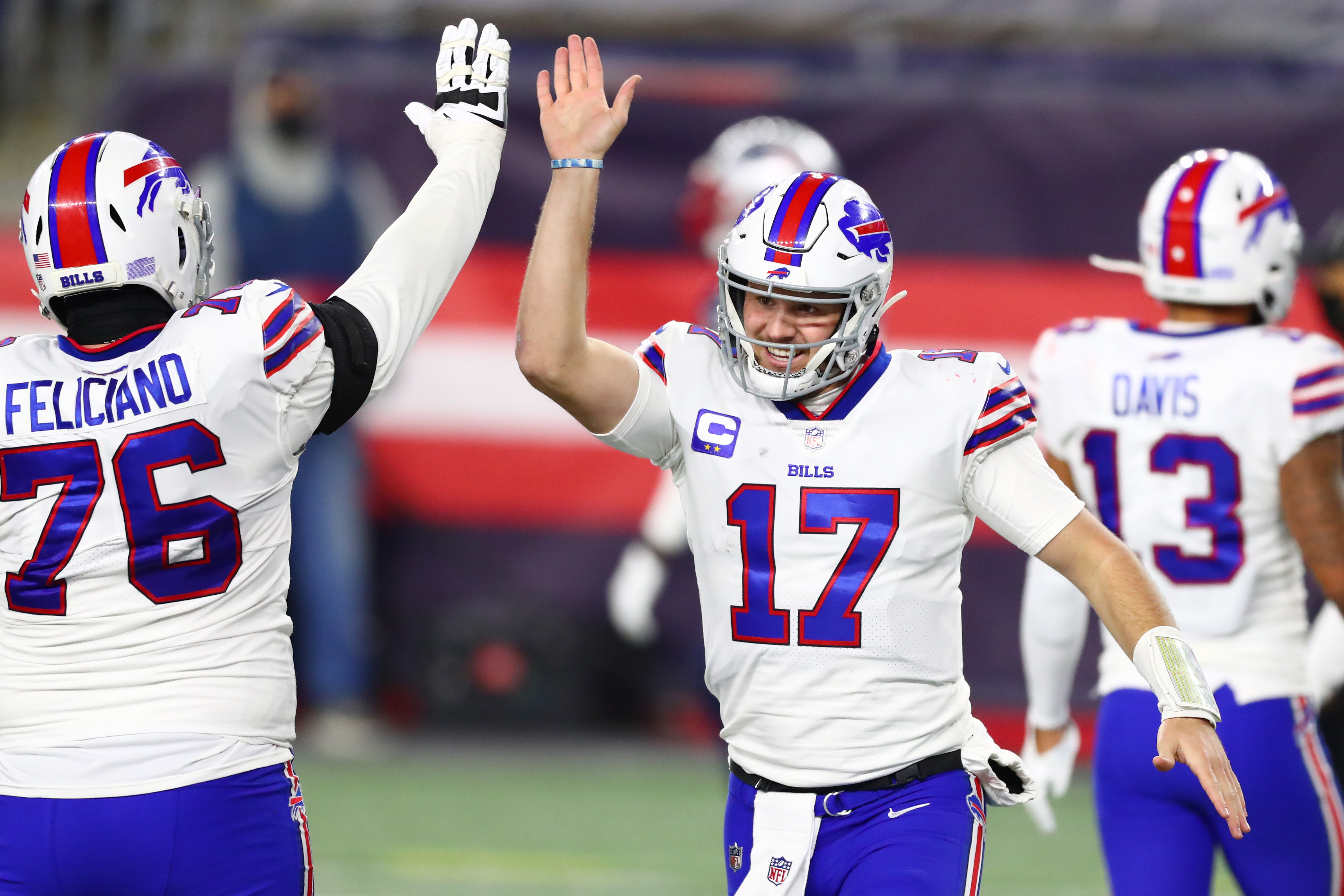 Josh Allen of the Buffalo Bills high-fives Jon Feliciano #76 during the second half against the New England Patriots at Gillette Stadium on December 28, 2020 in Foxborough, Massachusetts.