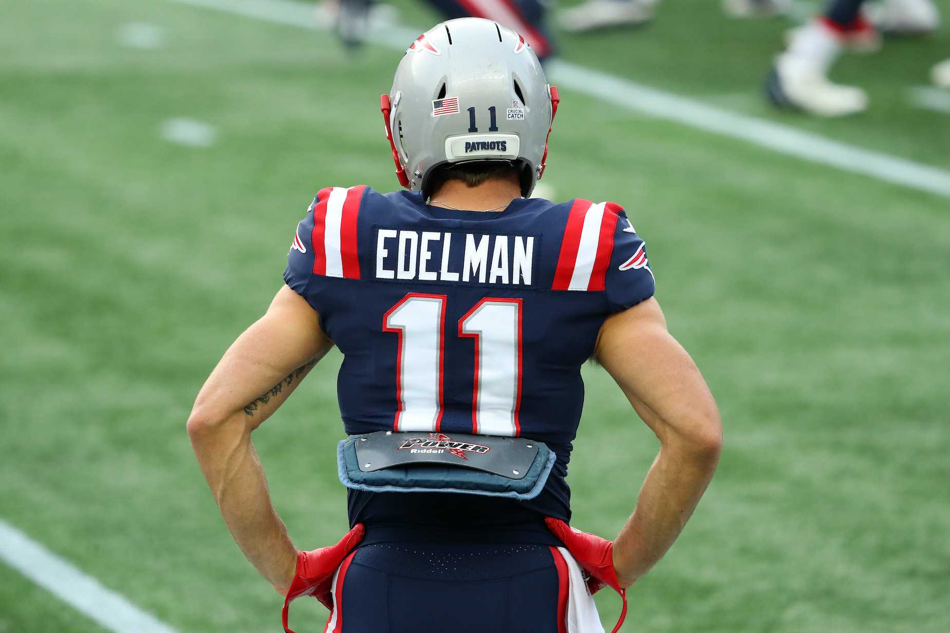 New England Patriots receiver Julian Edelman stands on the football field during his final NFL season