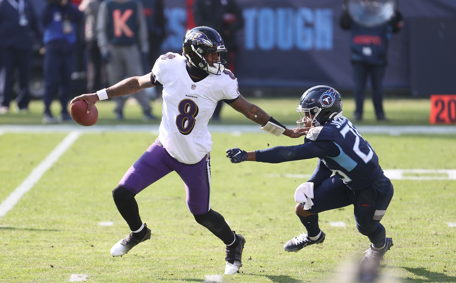 Lamar Jackson scrambles against the Tennessee Titans in the wild-card round of the NFL playoffs on Jan. 10, 2021. | Andy Lyons/Getty Images