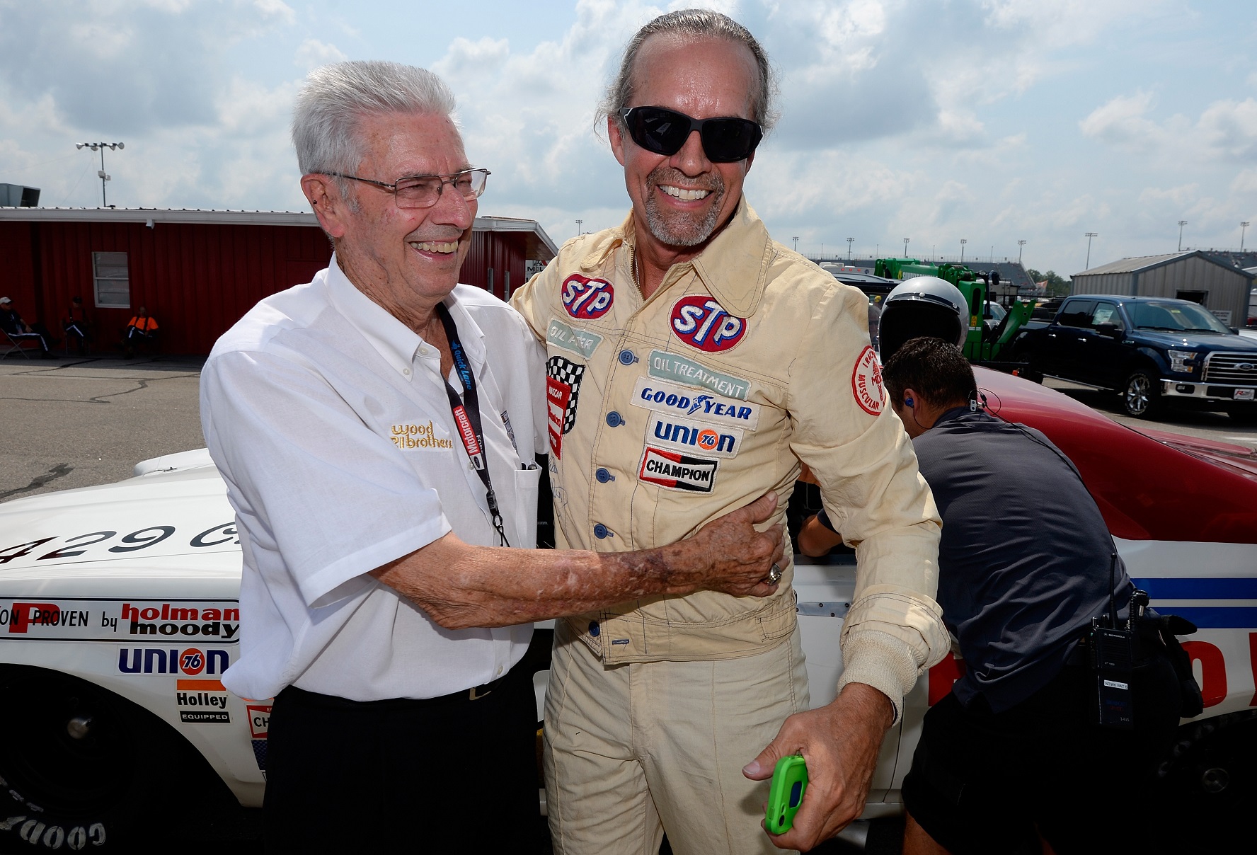 Retired driver Kyle Petty, right, and NASCAR Hall of Famer Leonard Wood stand with the Wood Brothers Racing 1972 Mercury prior to qualifying for the NASCAR Sprint Cup Series race at Darlington Raceway in September 2015. Robert Laberge/NASCAR via Getty Images