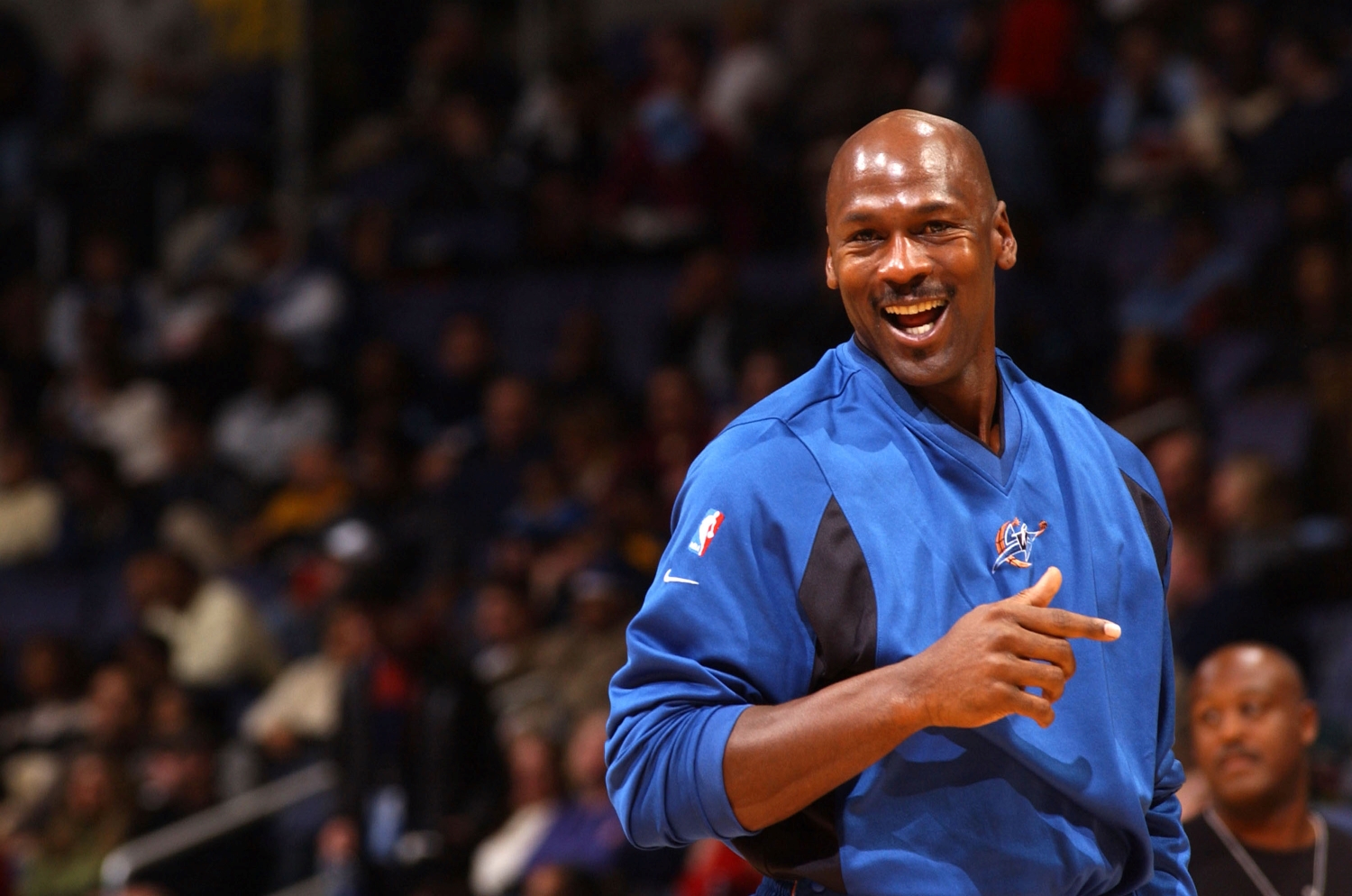 Michael Jordan smiles as he warms up before a game with the Wizards.