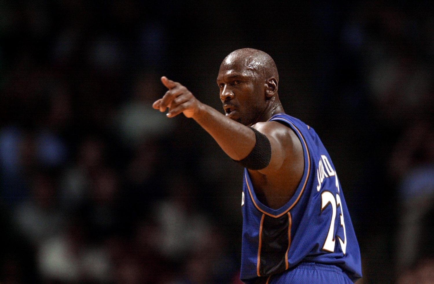 Michael Jordan points down the court during the first quarter of a preseason game with the Washington Wizards.