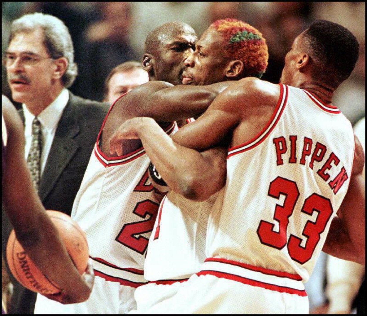 Michael Jordan and Scottie Pippen take down Dennis Rodman during a 1996 Bulls-Lakers matchup