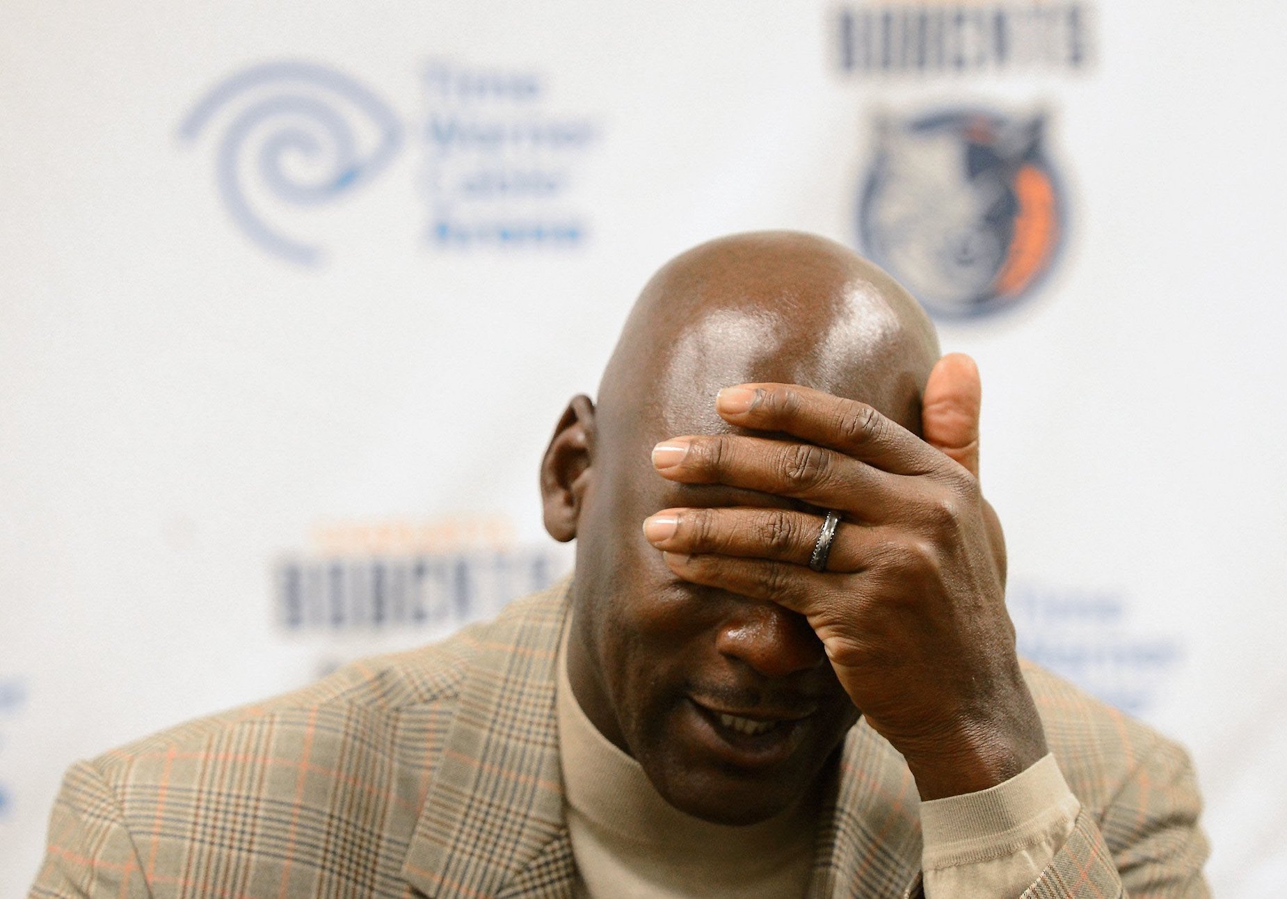 Michael Jordan reacts during a 2013 press conference.