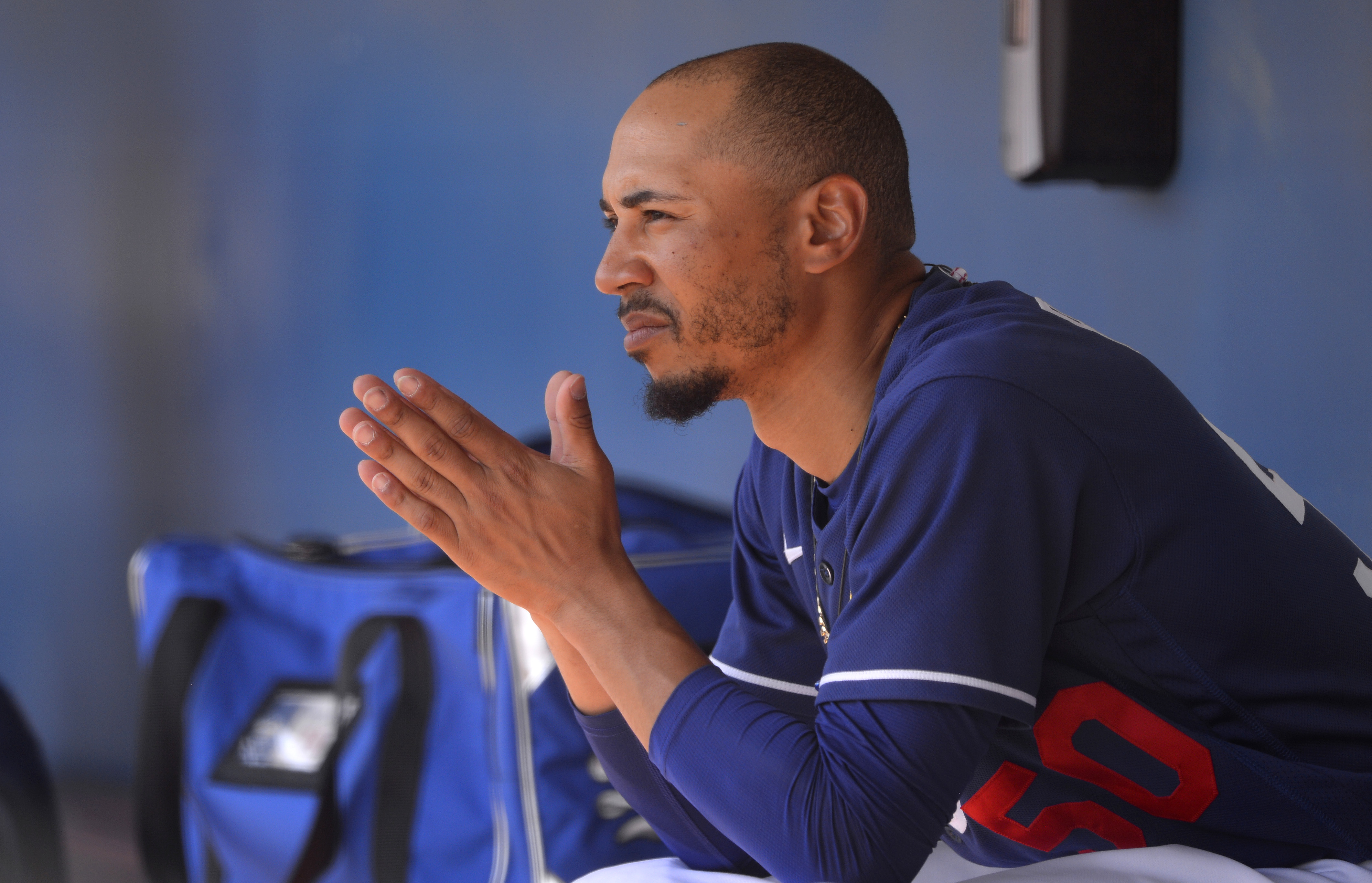 Mookie Betts of the Los Angeles Dodgers looks on from the dugout