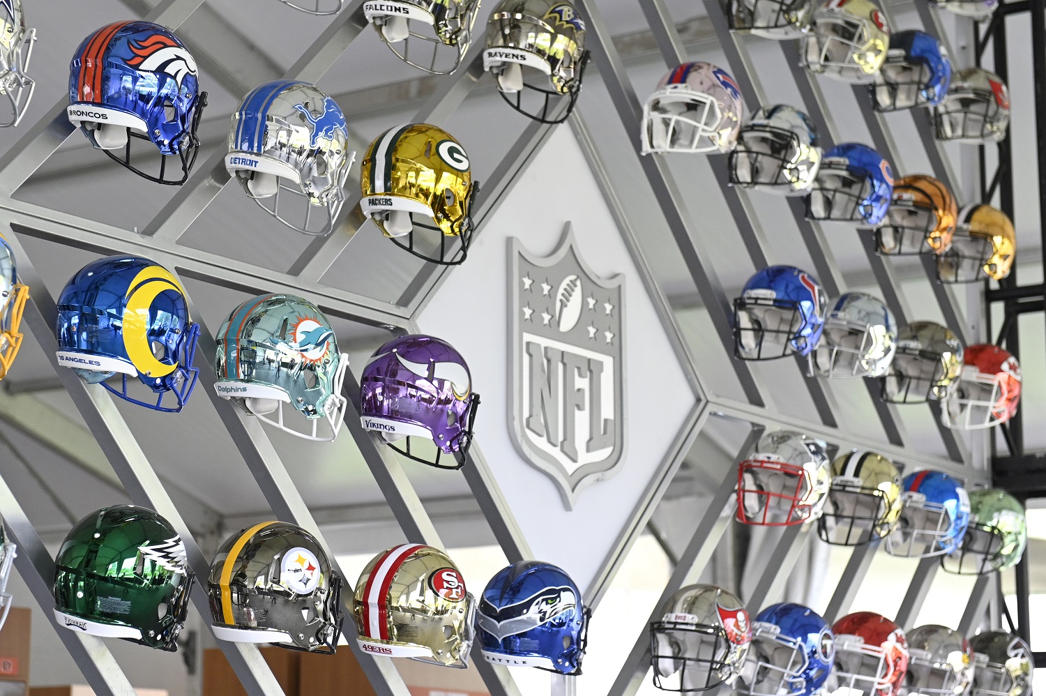 A wall of NFL team helmets is on display at the NFL Draft Experience in Cleveland.