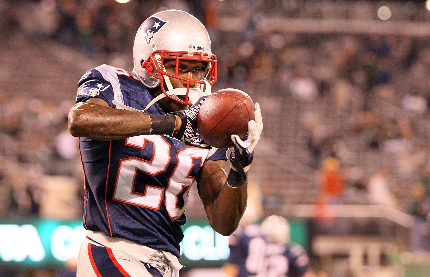 Phillip Adams catches a ball while warming up before a game during his brief time with the New England Patriots.