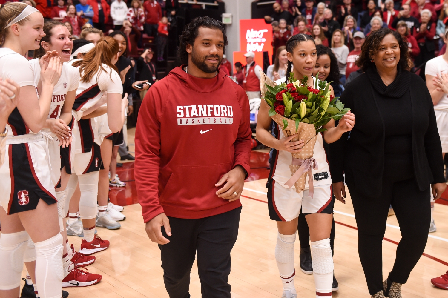 Seattle Seahawks quarterback Russell Wilson walks next to his sister, Anna Wilson, and their mother, Tammy Wilson, to celebrate senior day at Stanford.