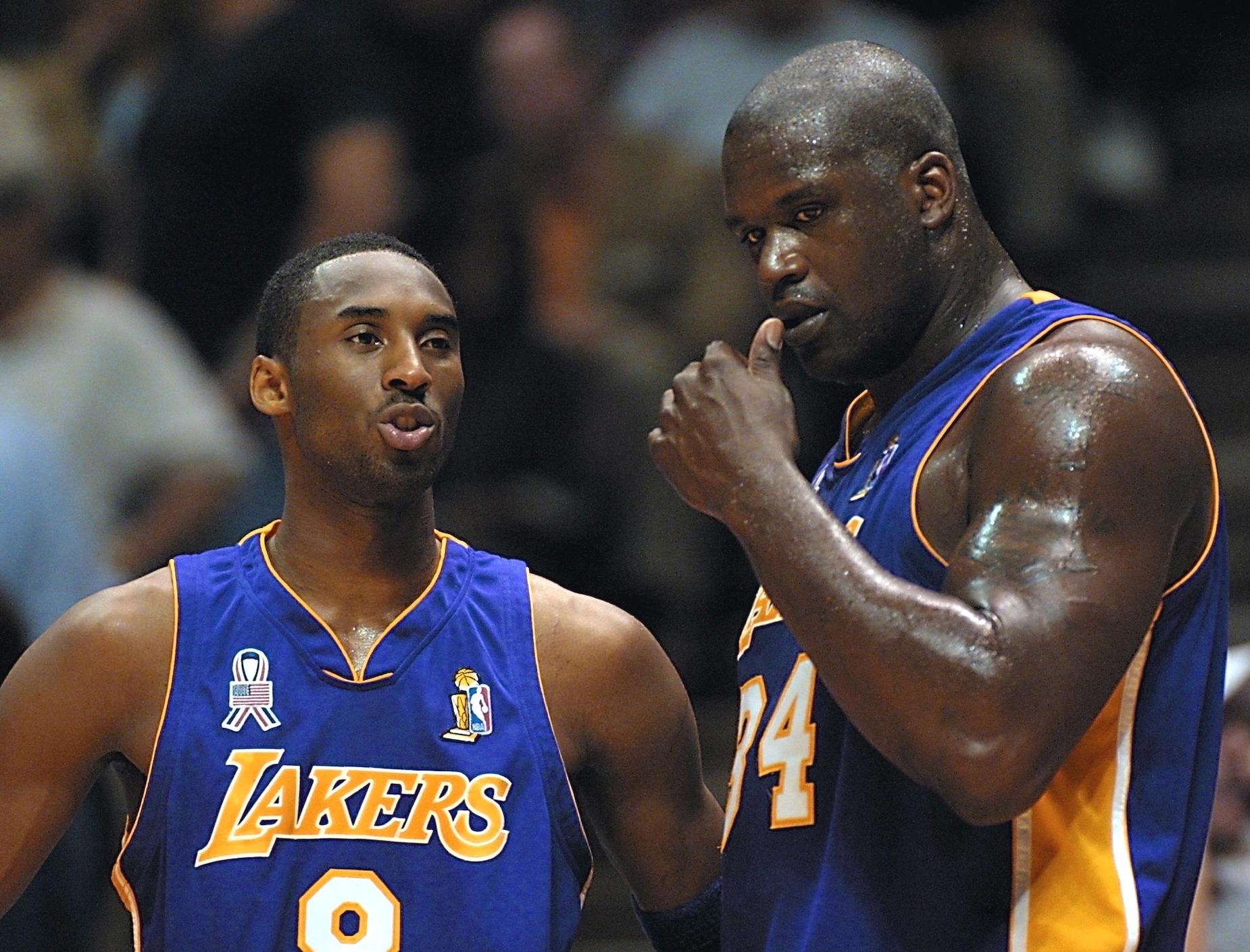 Lakers stars Kobe Bryant (L) and Shaquille O'Neal (R) talk during the 2002 NBA Finals.