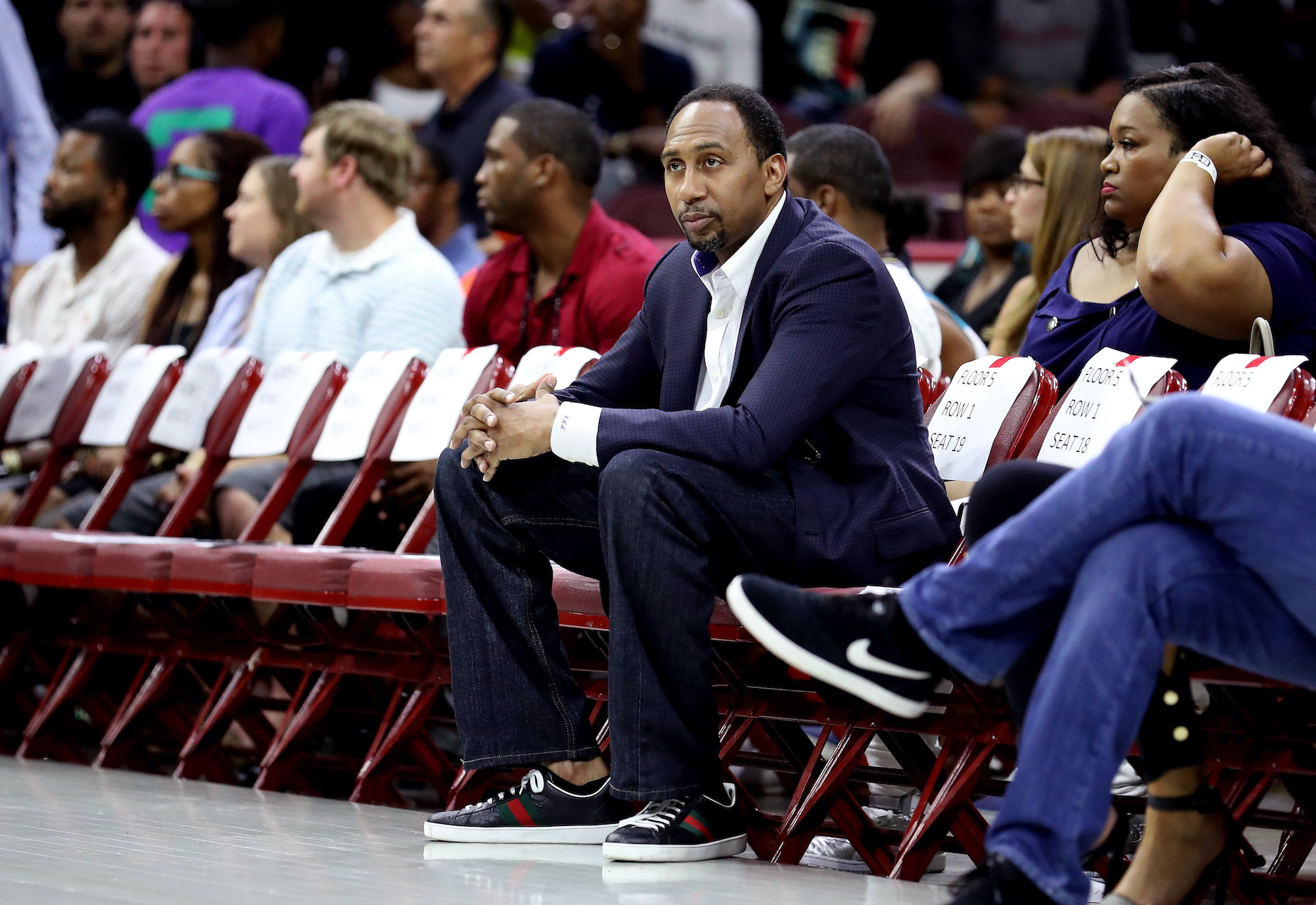Stephen A. Smith sits courtside in Philadelphia in 2017.