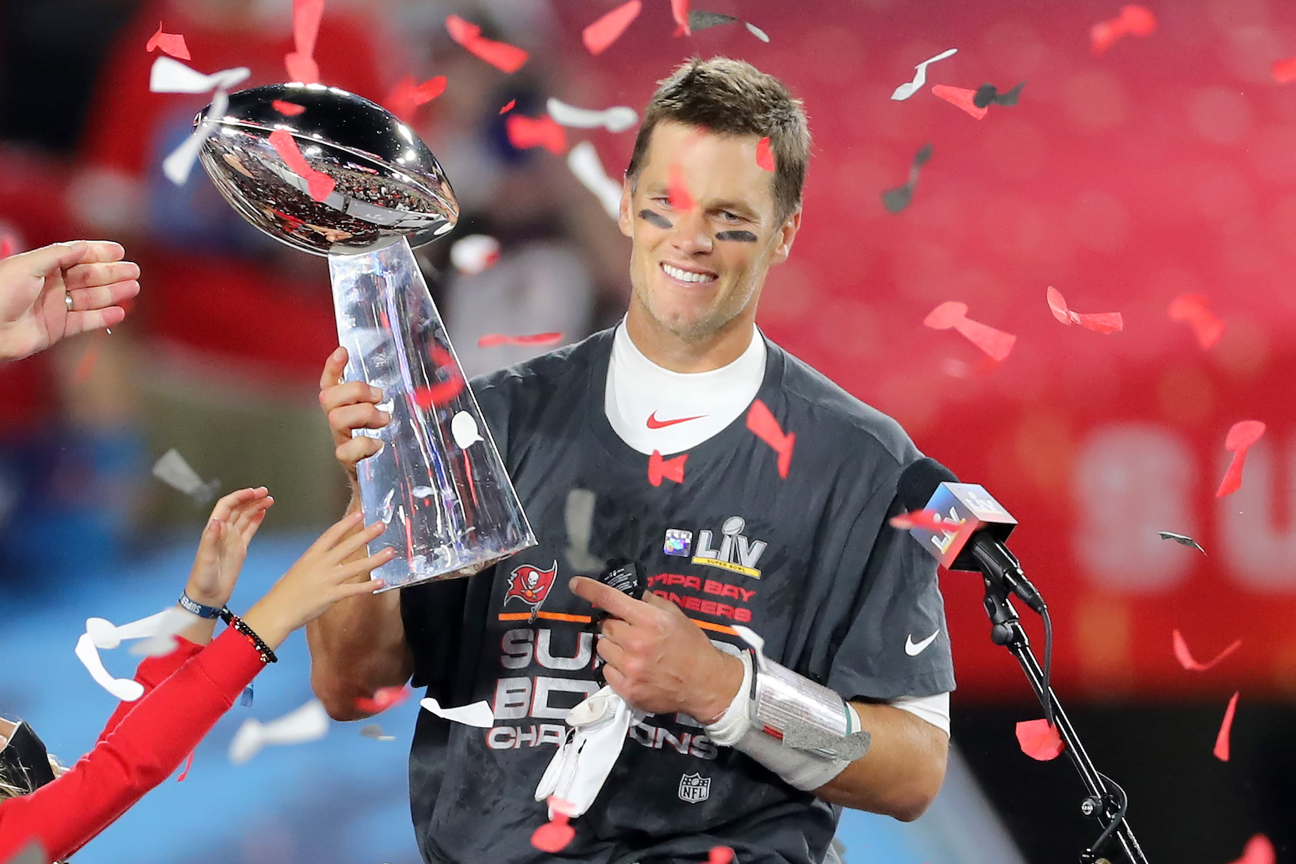 Tampa Bay Buccaneers quarterback Tom Brady lifts the Lombardi Trophy after victory in Super Bowl 55
