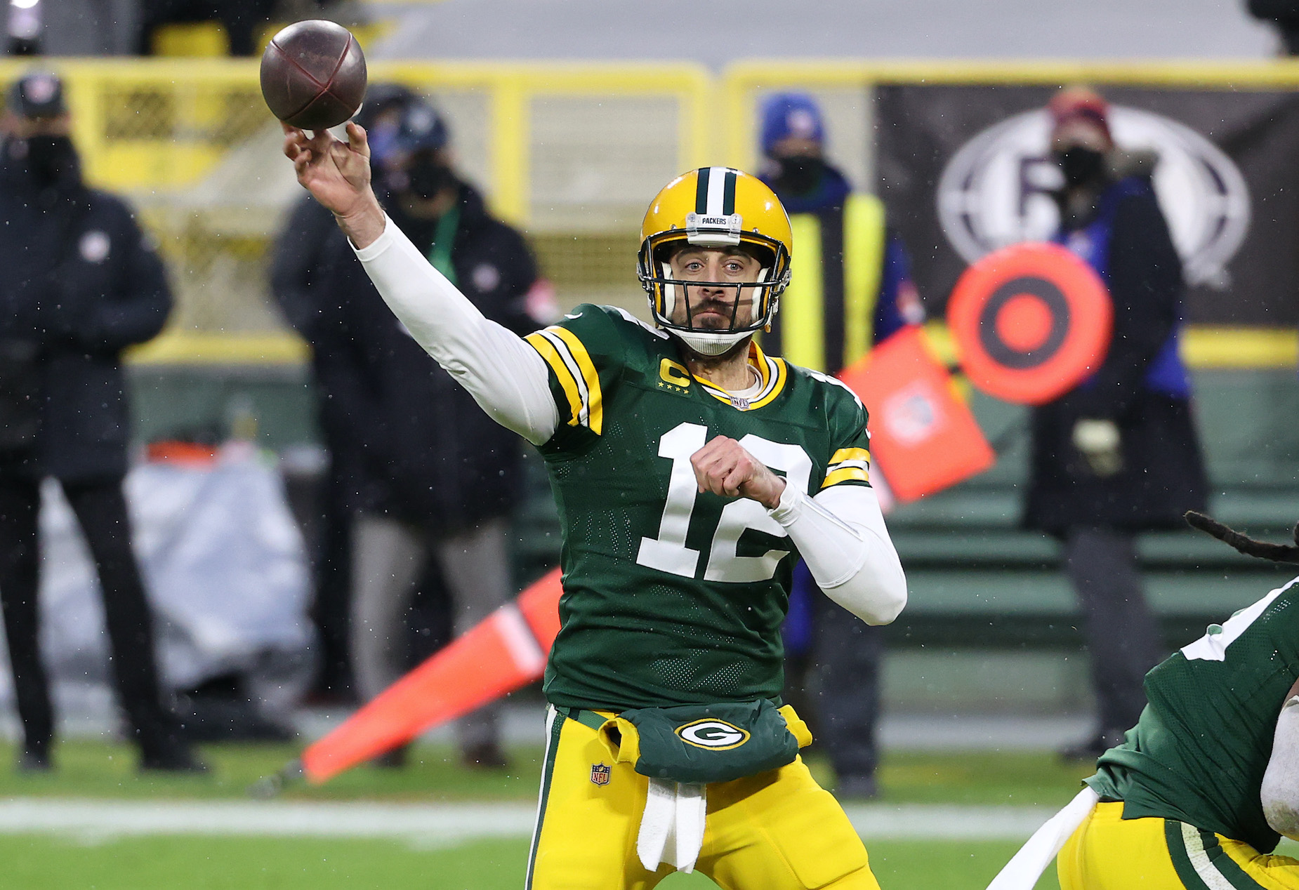Green Bay Packers quarterback throws a pass during a 2021 playoff game.