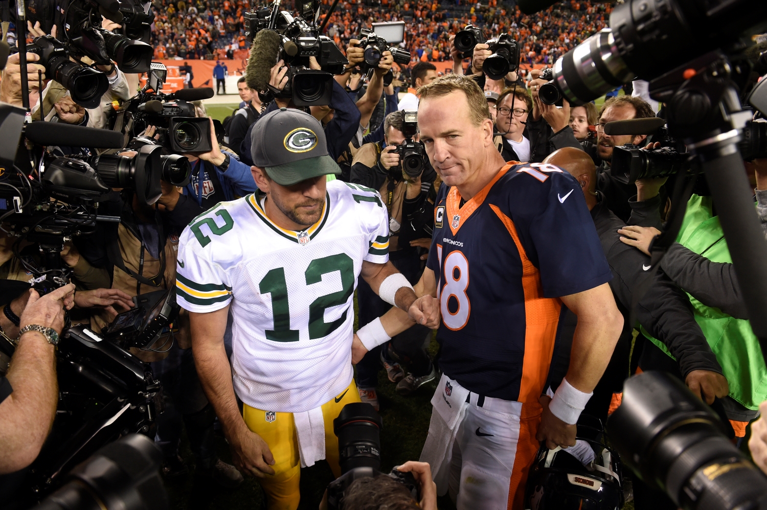 Aaron Rodgers talks to Peyton Manning after a game between the Packers and the Broncos.