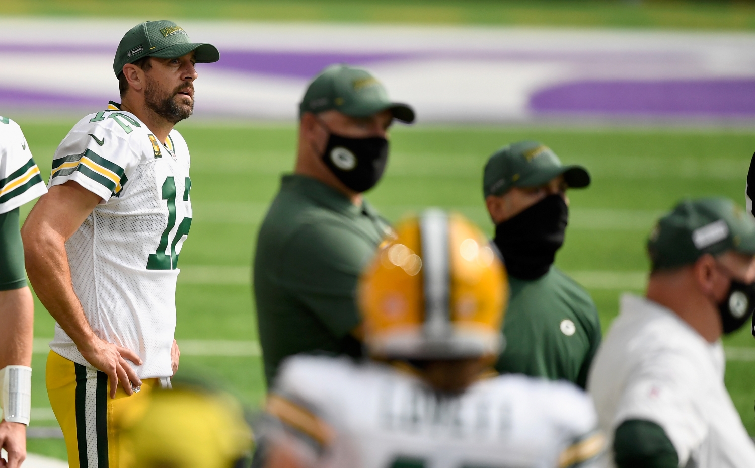 Green Bay Packers quarterback Aaron Rodgers stands on the sidelines during a game.