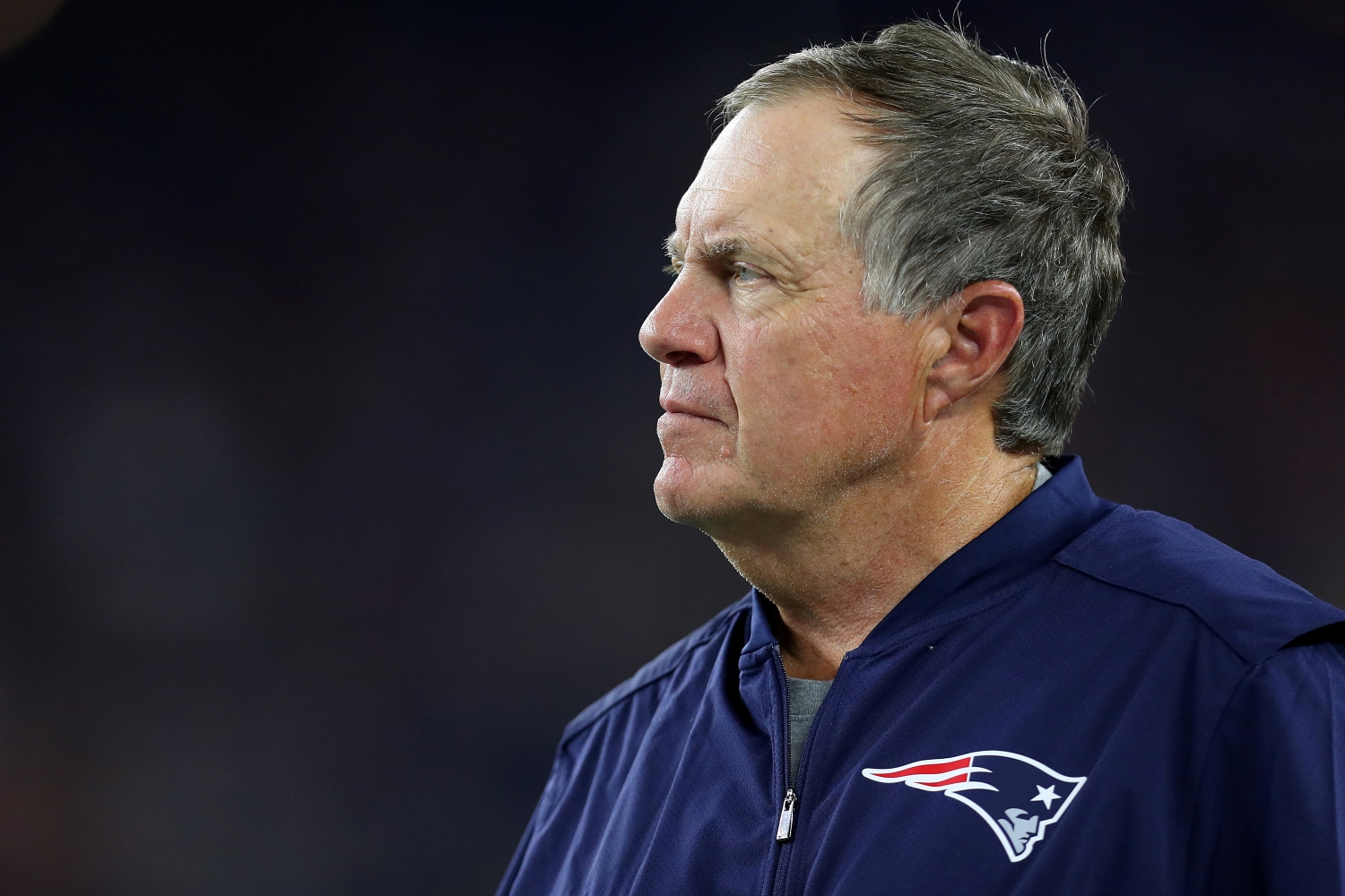 New England Patriots head coach Bill Belichick looks on during a game.