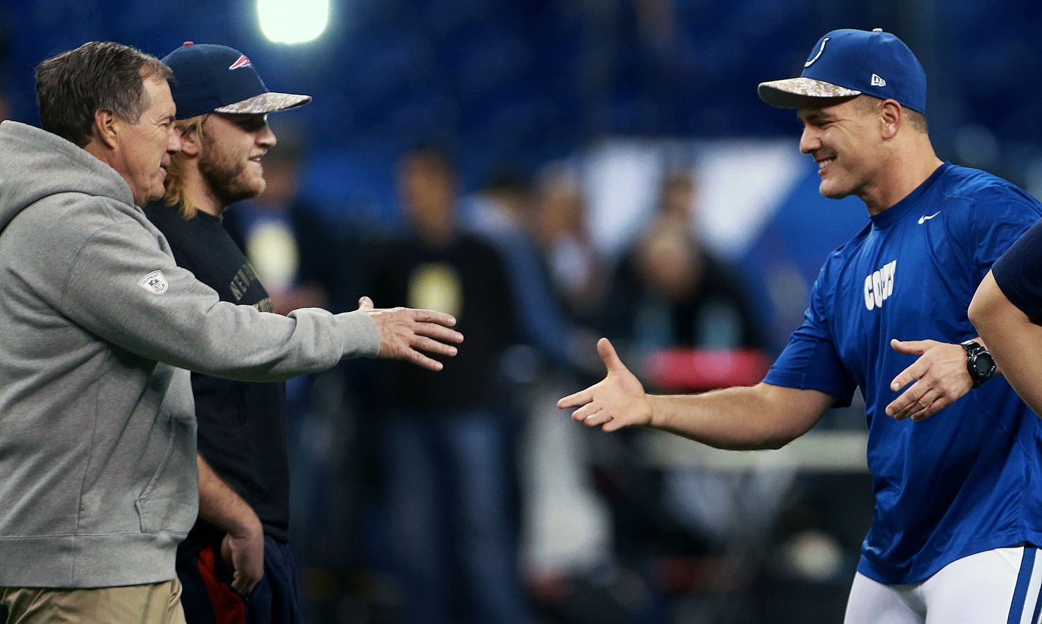 Patriots head coach Bill Belichick shakes hands with Colts kicker Adam Vinatieri before a game.